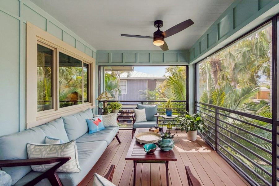 Exterior screened porch sitting area blue sofas ceiling fan — Custom home addition, Longboat Key