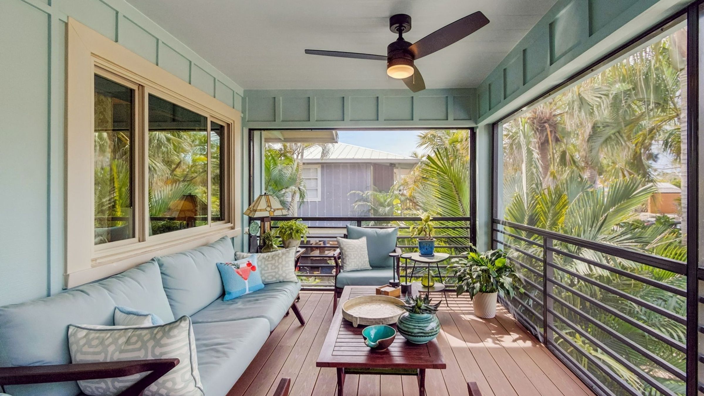 Exterior screened porch sitting area blue sofas ceiling fan — Custom home addition, Longboat Key