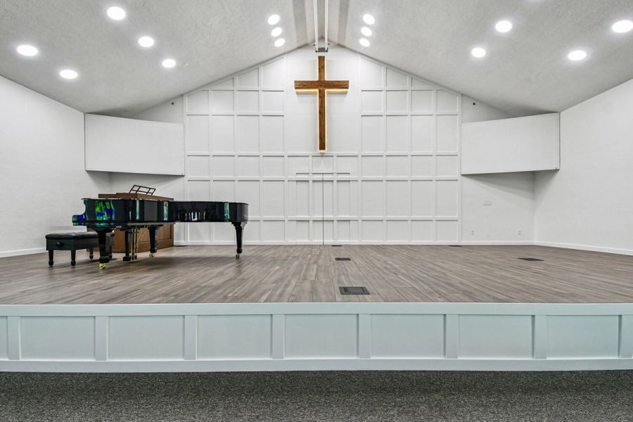 Stage area with grand piano and wooden cross — Roser Memorial Community Church, Anna Maria, FL