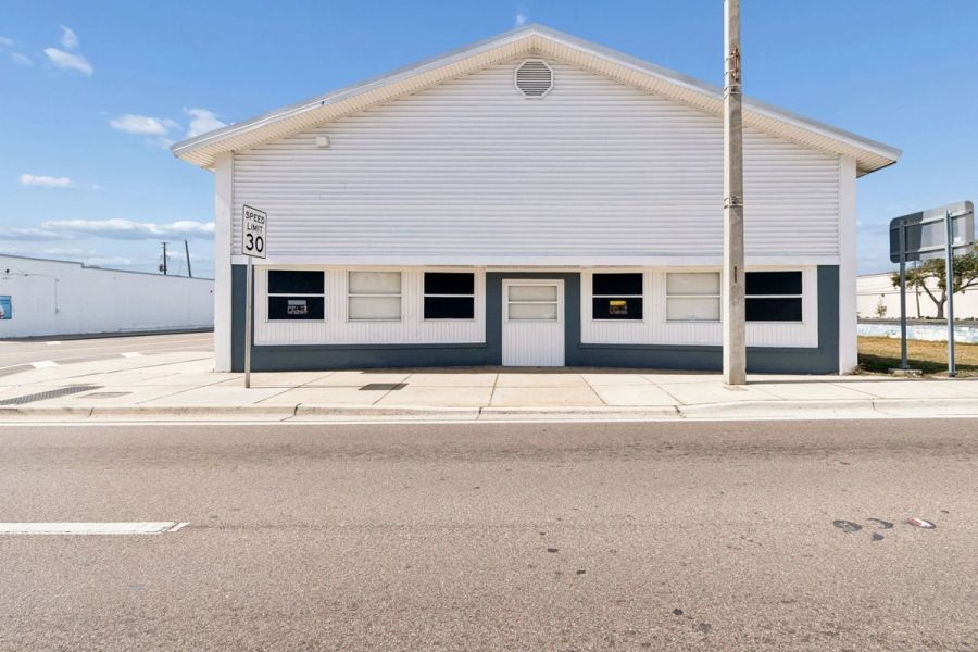 Annex white siding street facing facade multiple windows — Commercial building renovation, Palmetto