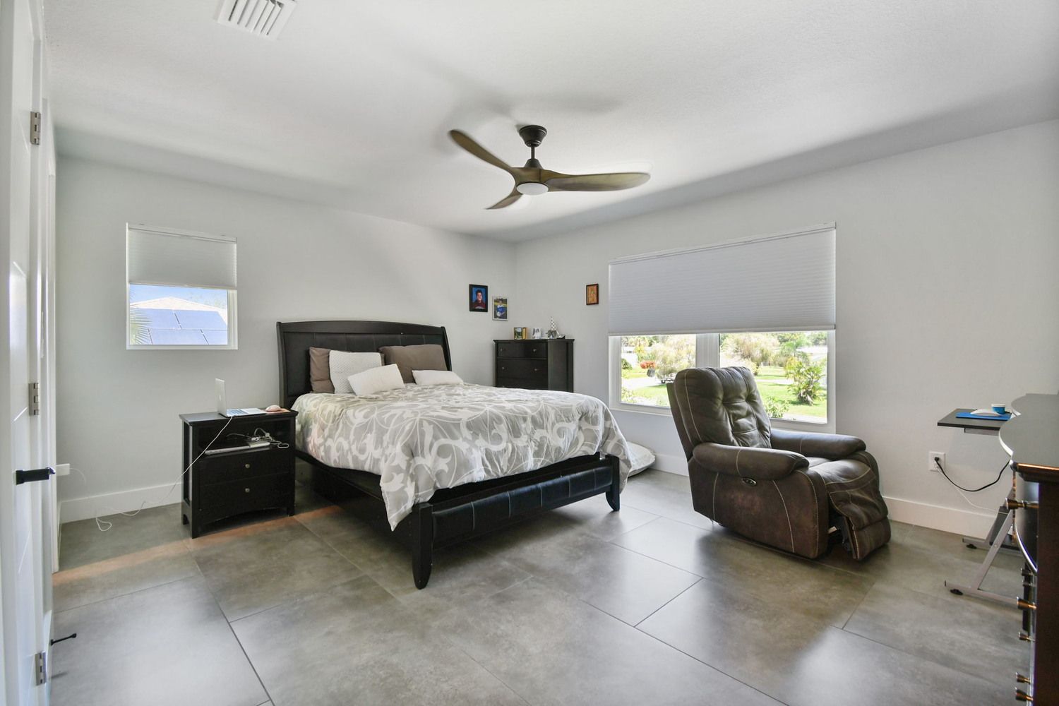 Spacious master bedroom with large windows and tile flooring — Waterfront home renovation, Bradenton, FL
