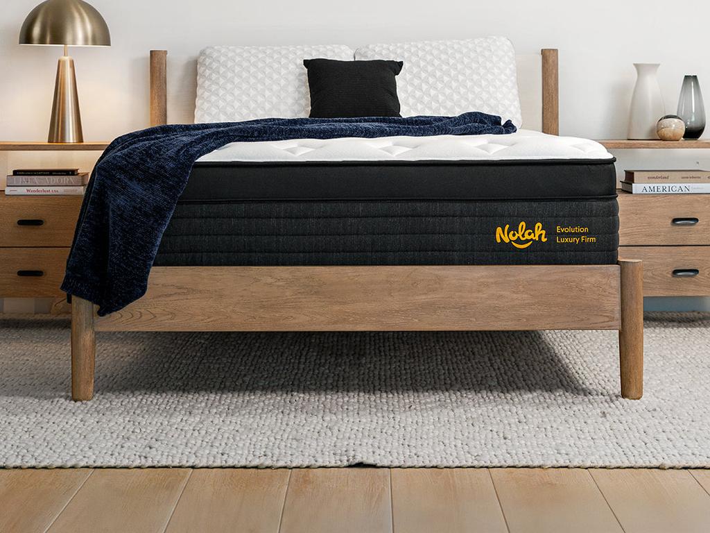 Front view of the Evolution Luxury Firm mattress on a wood bed frame
