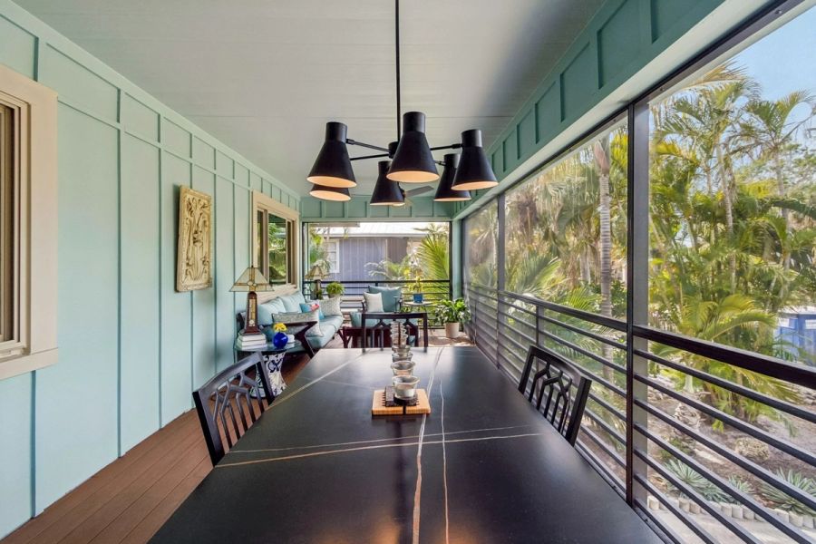 Exterior screened porch dining table black pendant light teal walls — Custom home addition, Longboat Key