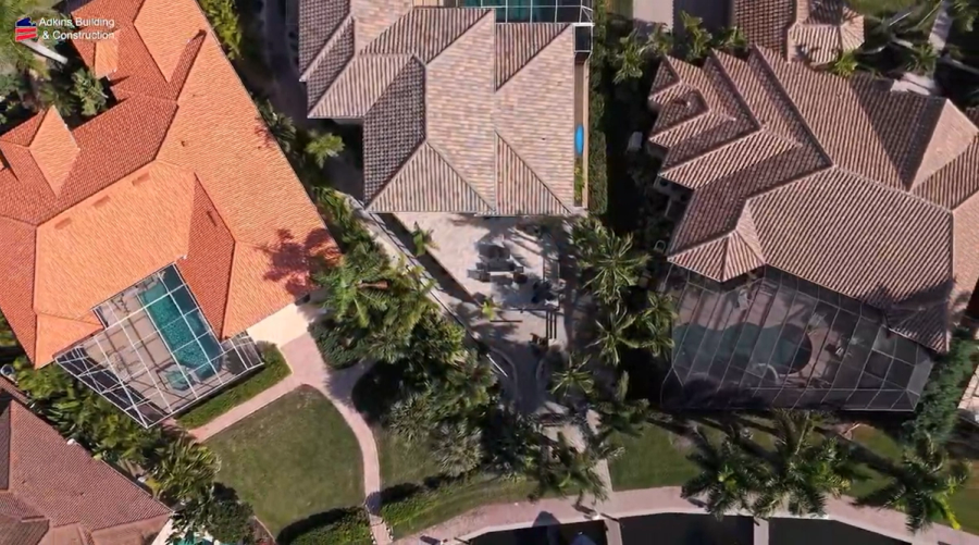 Aerial view of the tile roofs and screened pool enclosure — Custom home addition, Cortez
