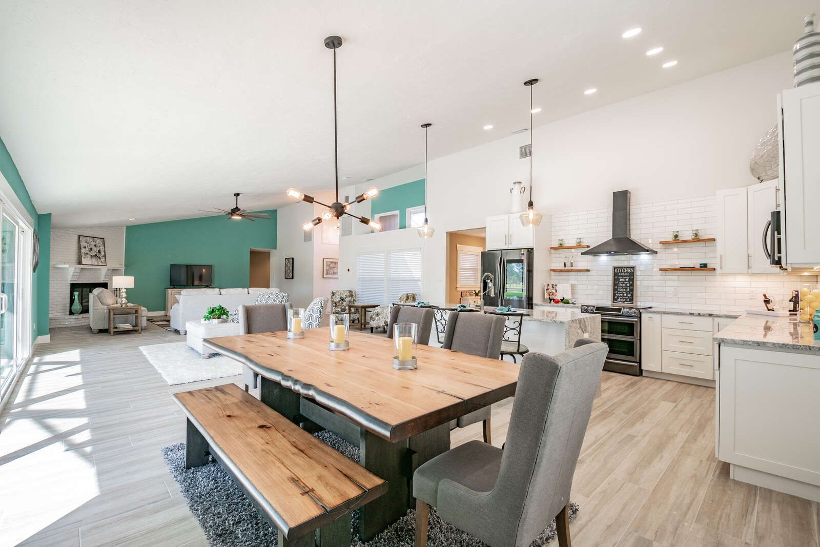 Dining table with bench and open kitchen — Custom home addition, pool, and renovation, Bradenton