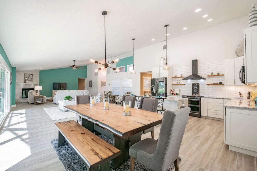 Dining table with bench and open kitchen — Custom home addition, pool, and renovation, Bradenton