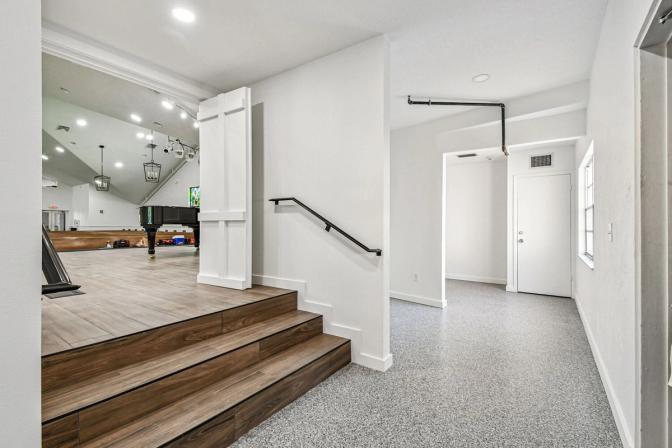 Transition space with wood steps leading to sanctuary in custom home project by Adkins Building & Construction in Anna Maria, FL