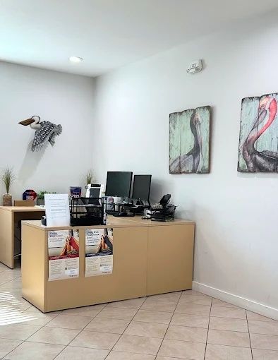 Reception desk with coastal bird artwork, Bradenton Research Center