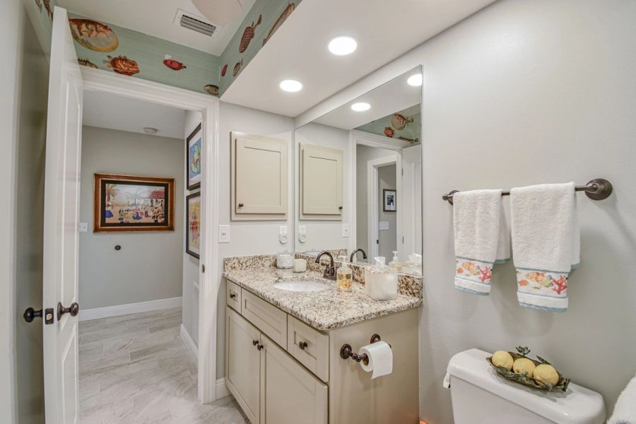 Tropical fish bathroom hallway — Custom design-build near IMG Academy, West Bradenton