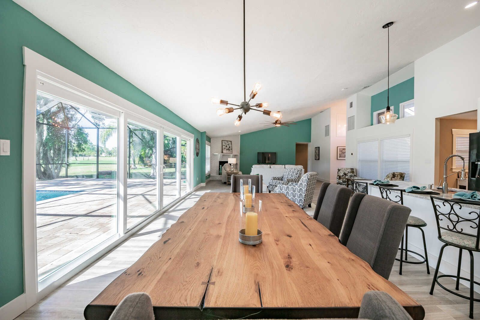 Dining table with sliding doors to pool — Custom home addition, pool, and renovation, Bradenton