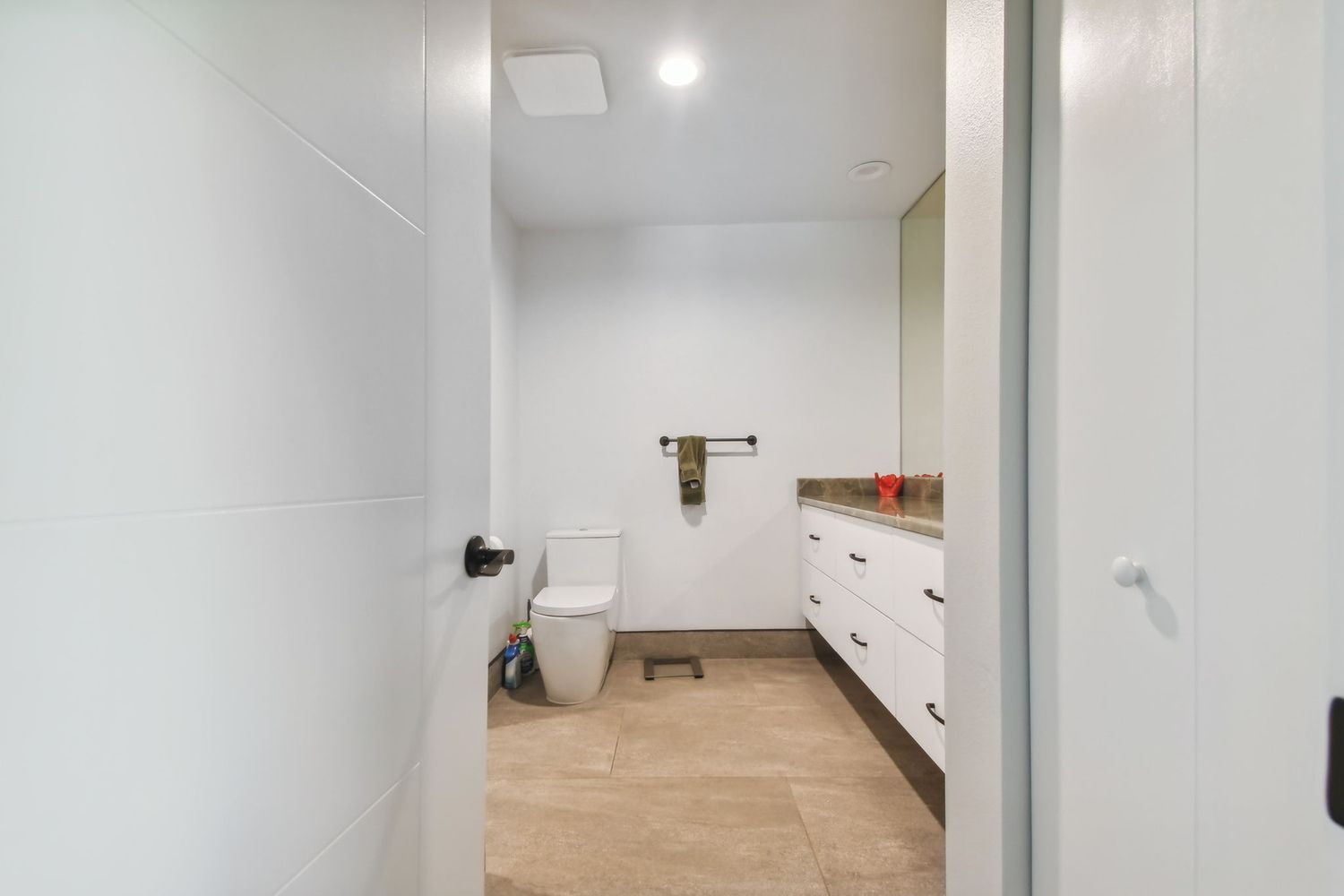 Modern bathroom with floating vanity and neutral tile — Waterfront home renovation, Bradenton, FL