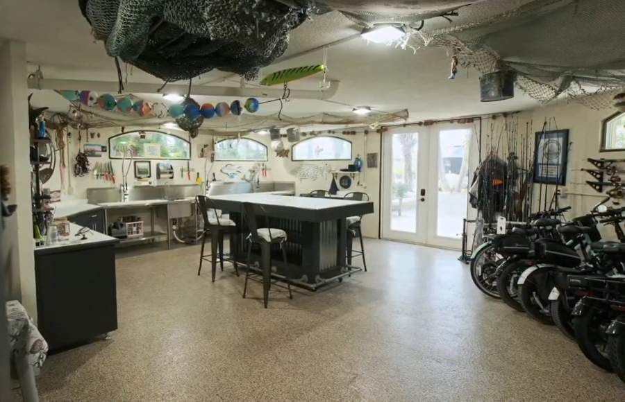 Fish camp room with island, storage and parked bikes — Custom home addition, Cortez
