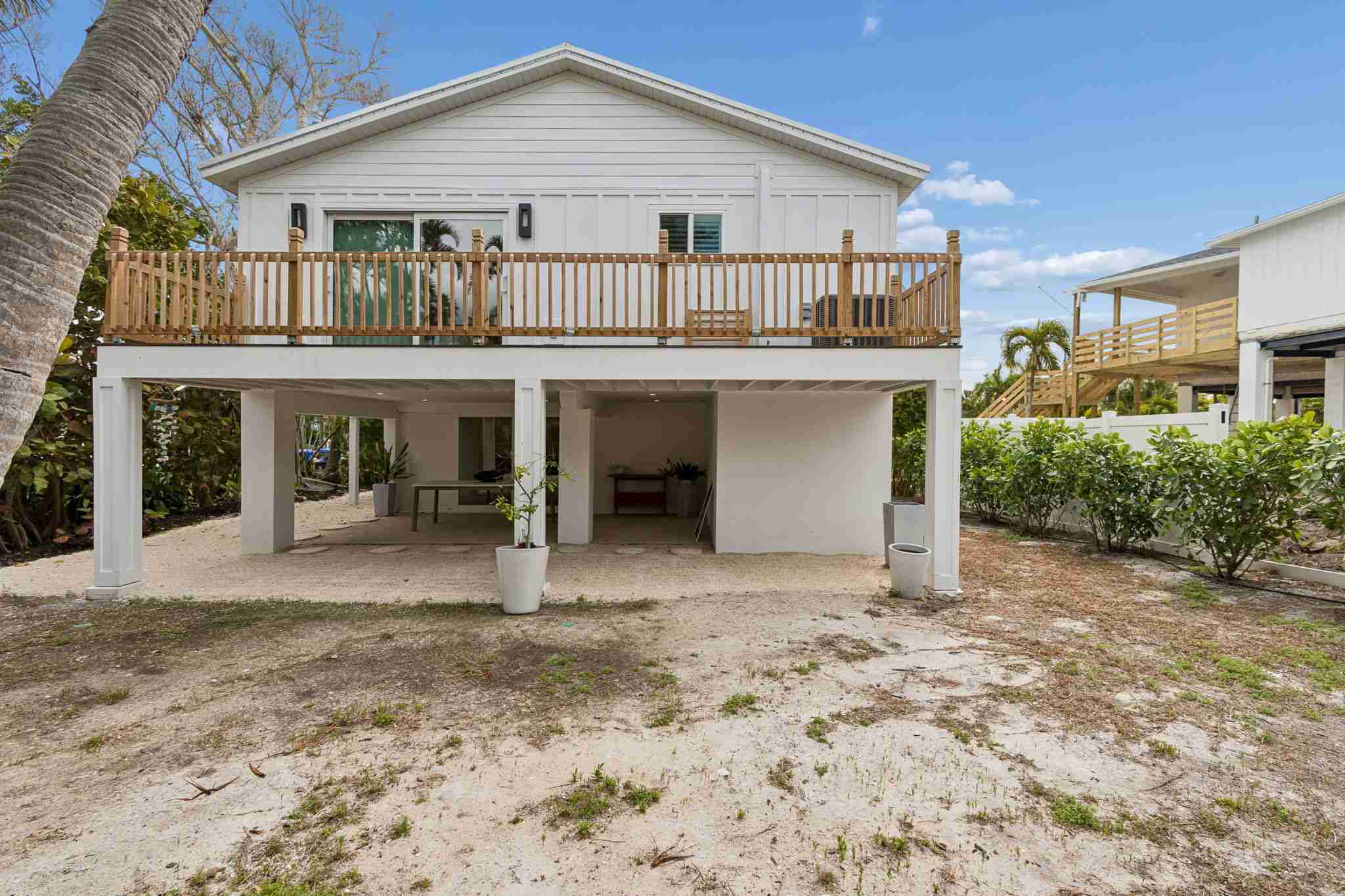 Rear exterior elevated stilts wood deck — New home construction, Longboat Key