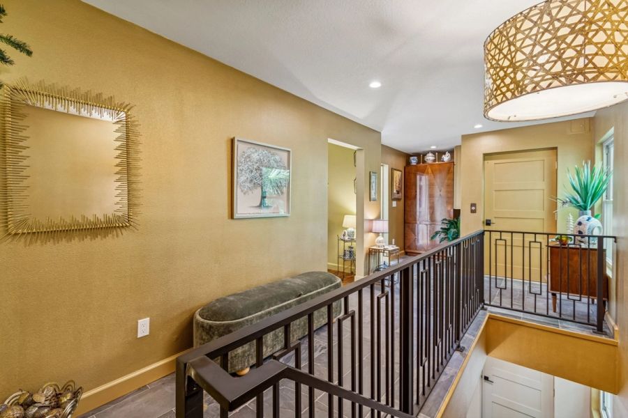 Interior upper level landing gold accent wall iron railing — Custom home addition, Longboat Key