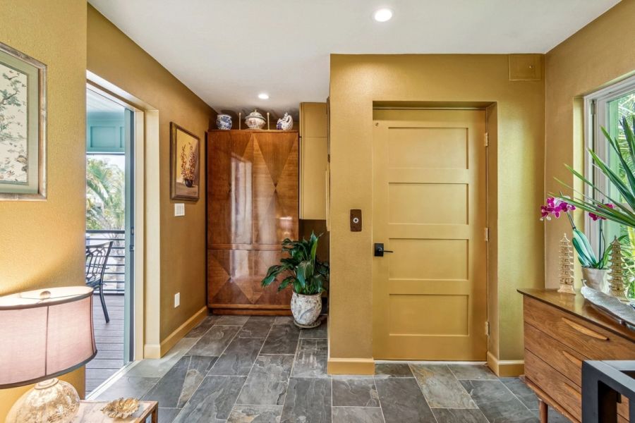 Interior upper level foyer gold walls elevator door wood armoire — Custom home addition, Longboat Key