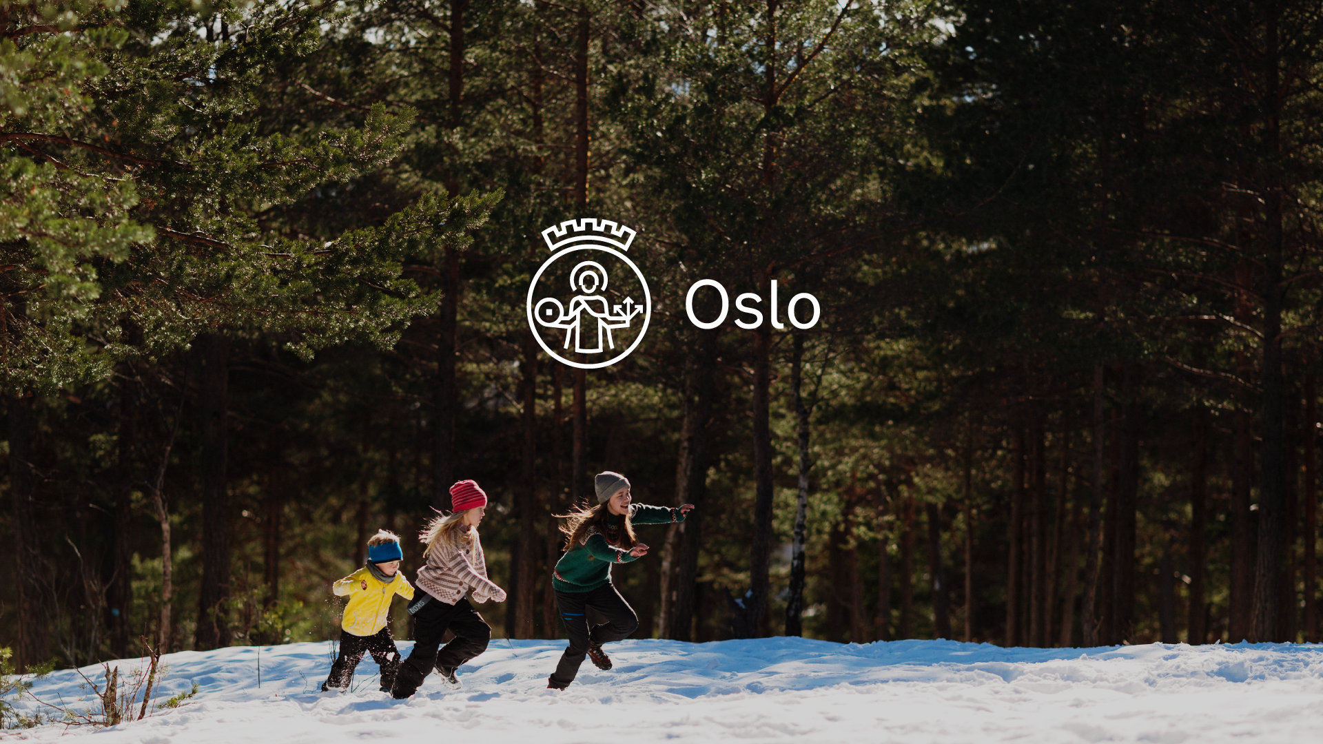 A photo of a forest with snow on the ground, three people are walking in the snow. The new Oslo logo is in the centre of the image, a white logo with a simplified image of Saint Halvard.