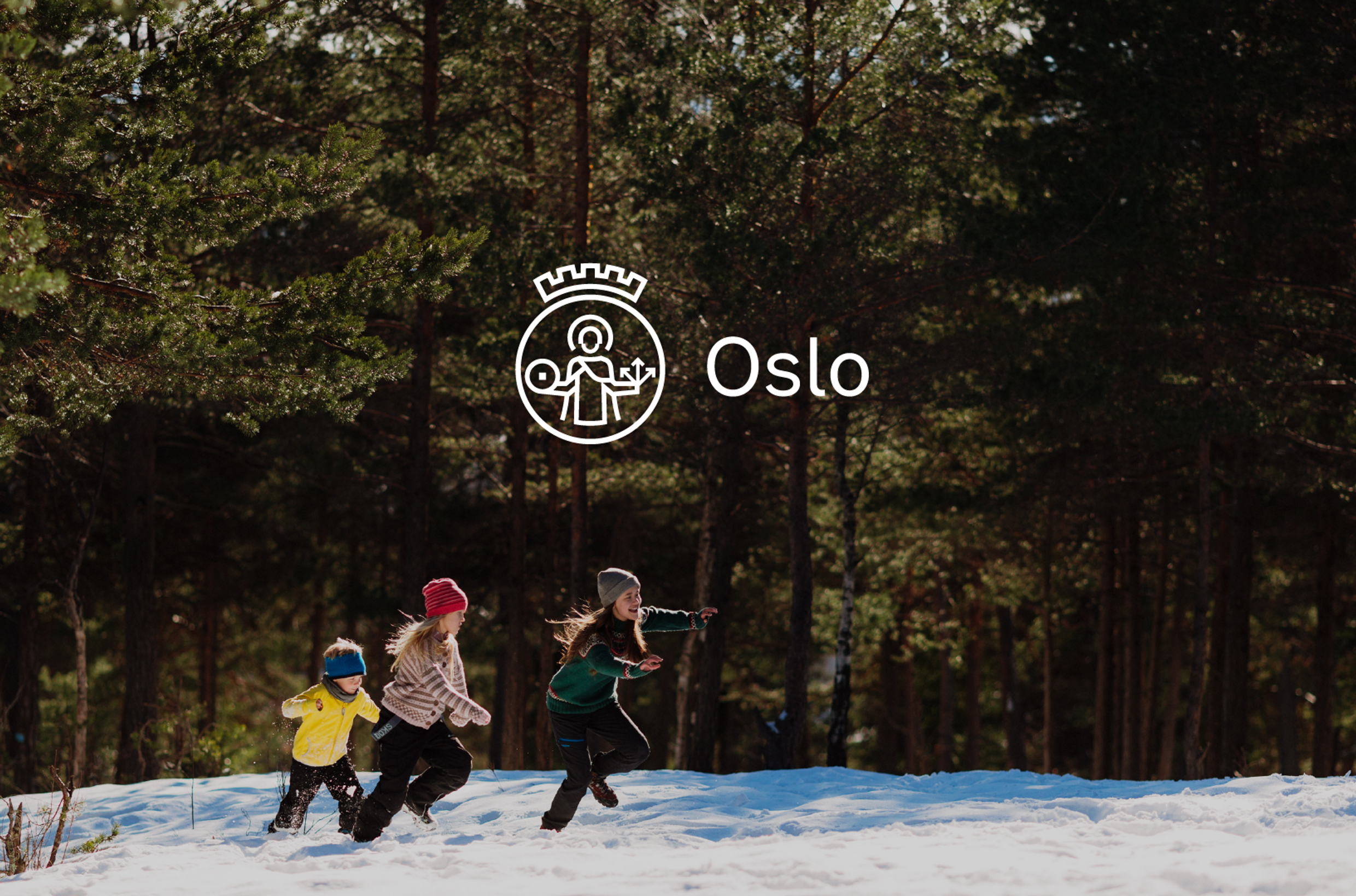 A photo of a forest with snow on the ground, three people are walking in the snow. The new Oslo logo is in the centre of the image, a white logo with a simplified image of Saint Halvard.