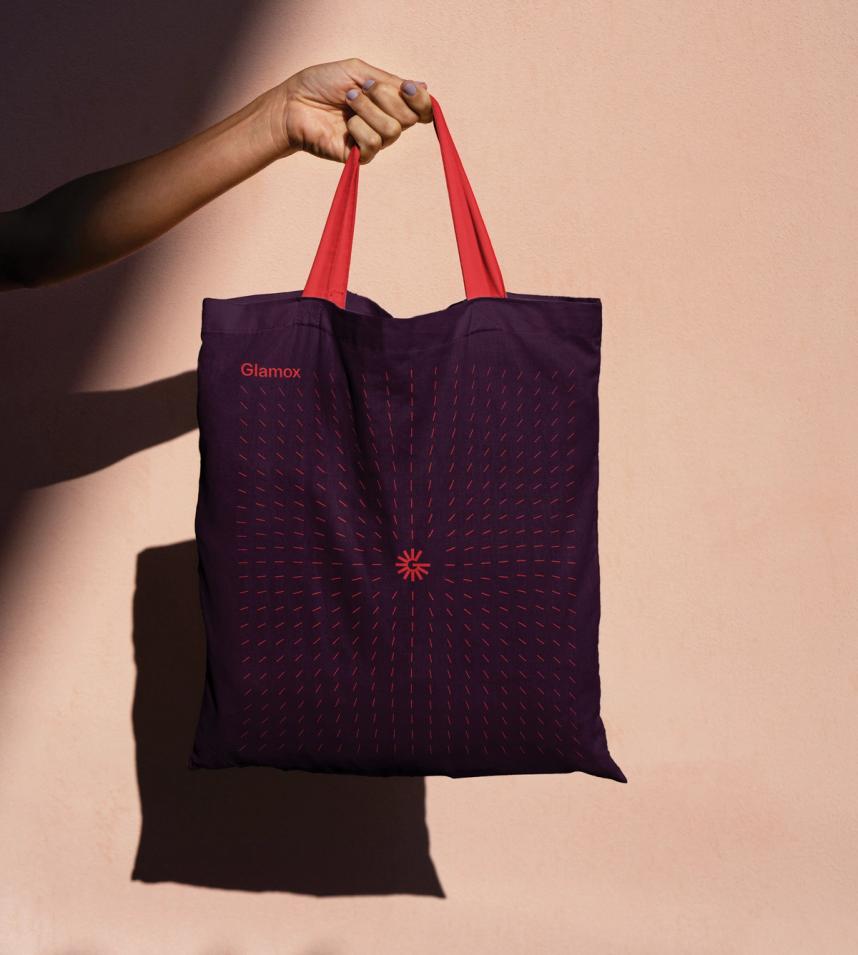 Totebag with the Glamox logo and graphic element. Red details on dark background.