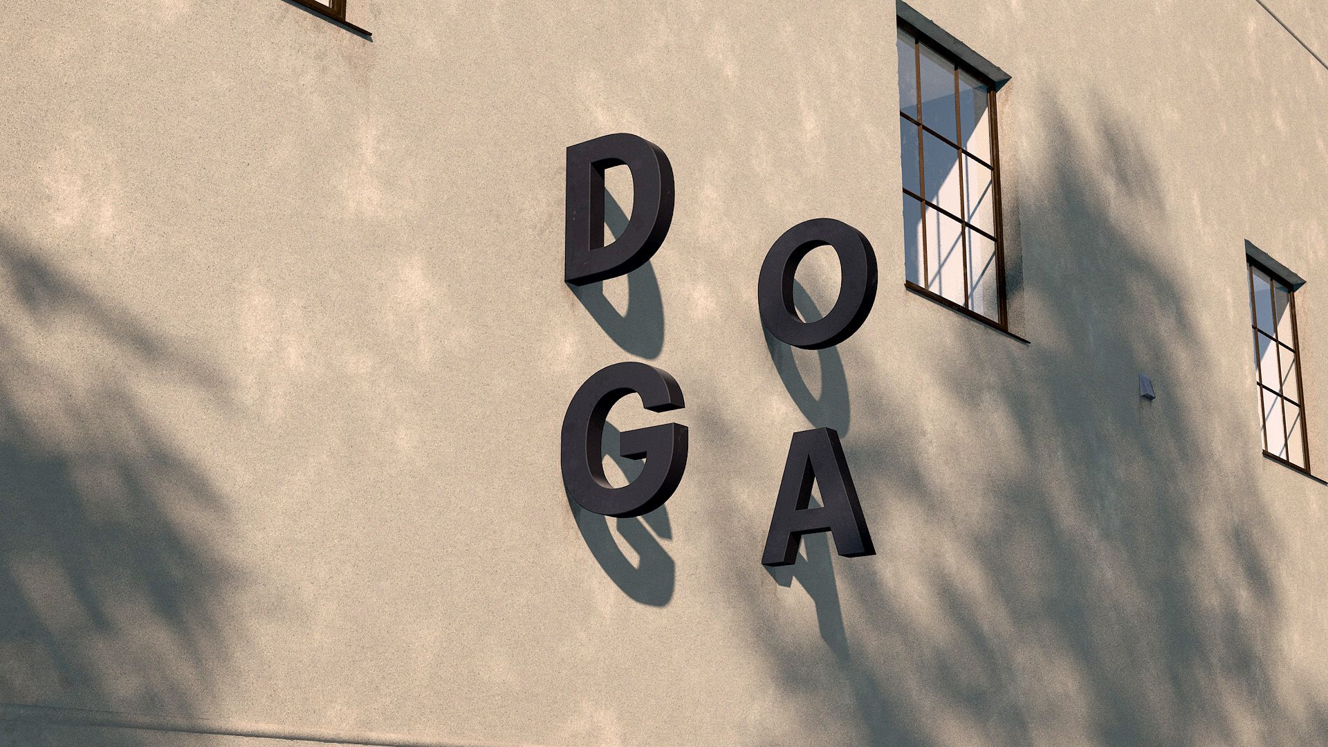 DOGA logo as signage on a beige wall. The font is sans serif.