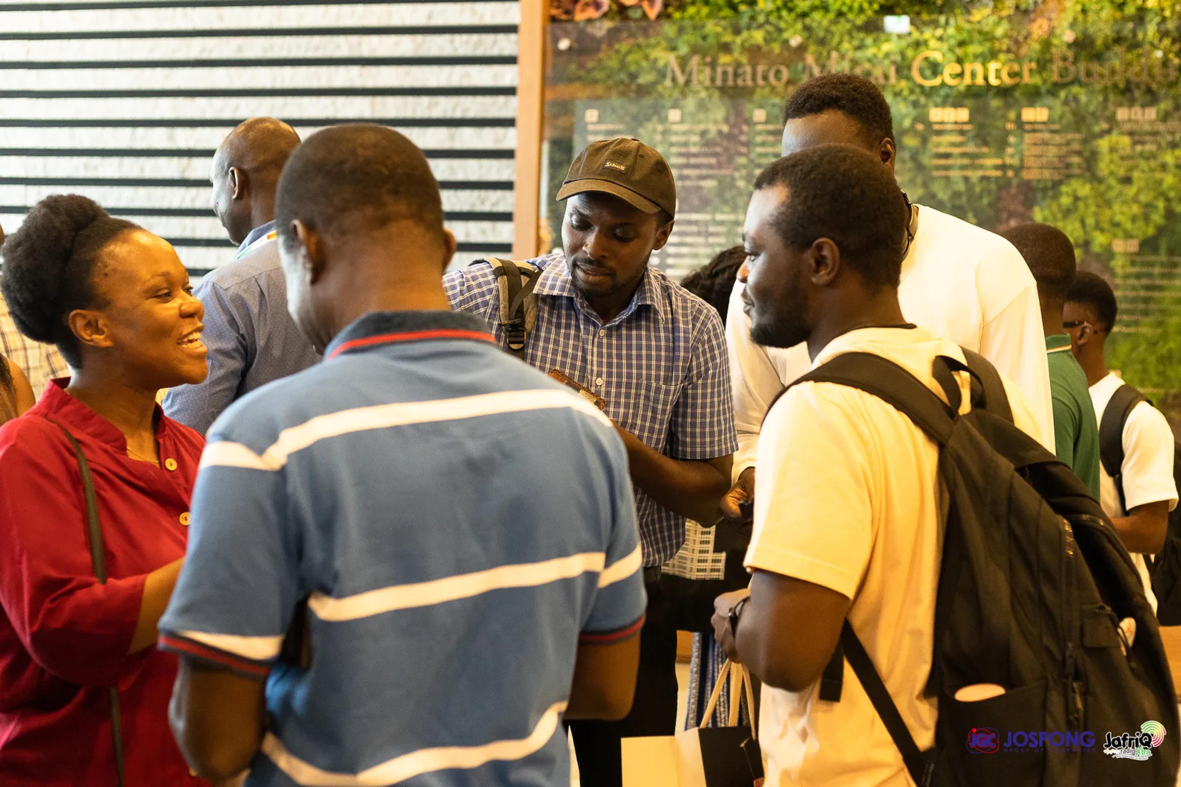 Attendees mingle and network in the lobby after the meeting