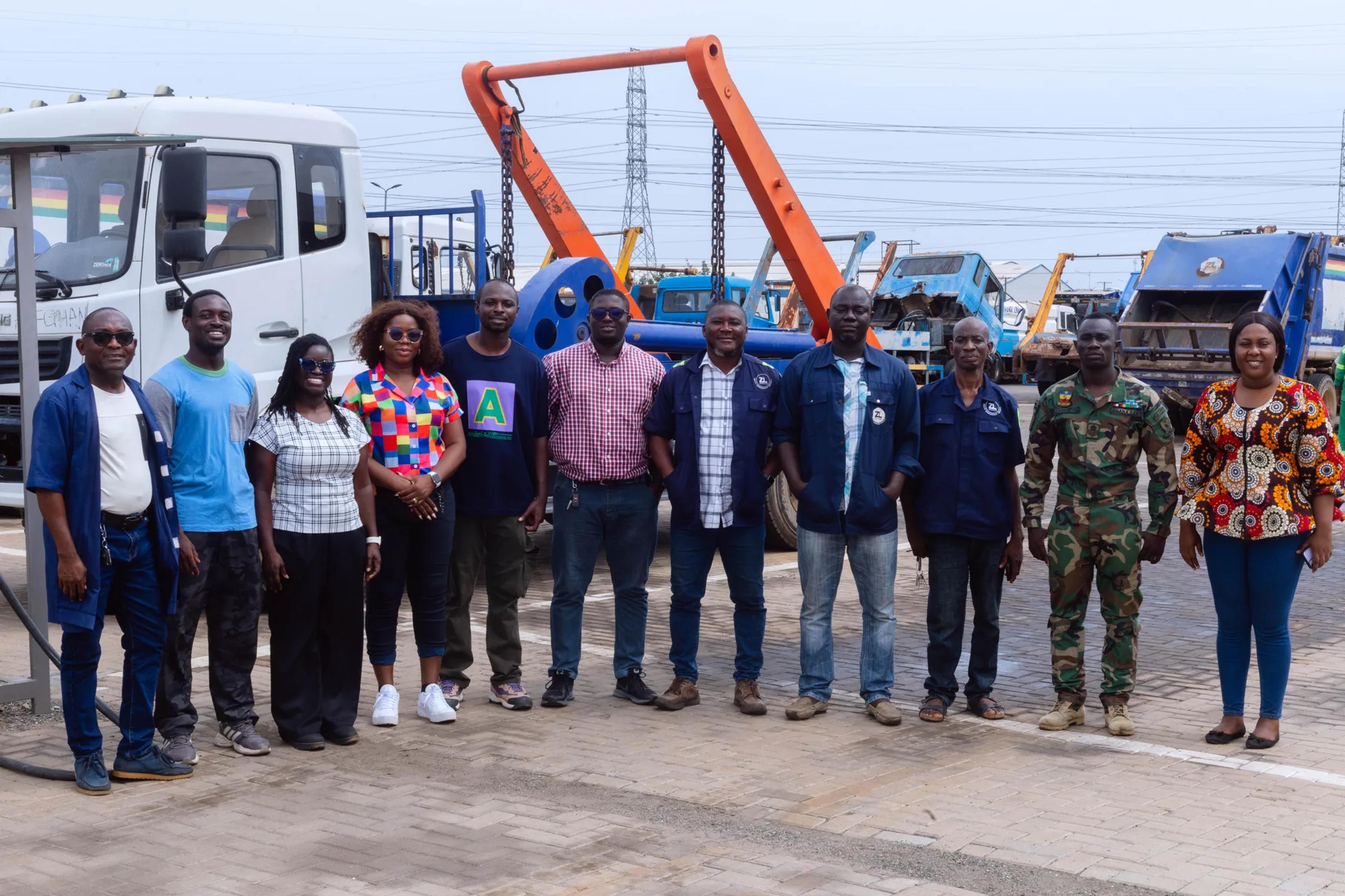 The team with workshop staff in front of waste collection trucks