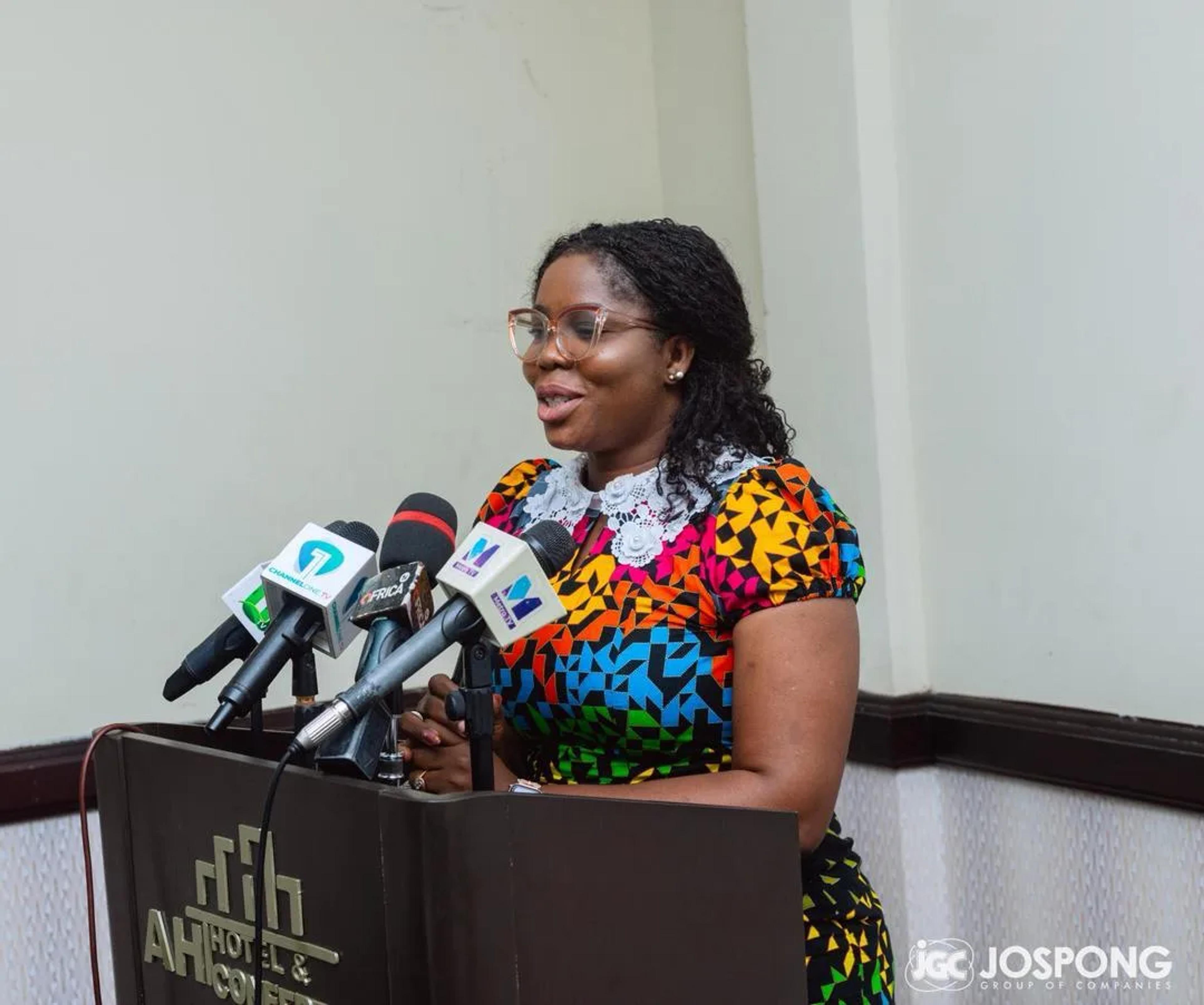 Caroline Awuye speaking at the podium at the signing of the memorandum of understanding