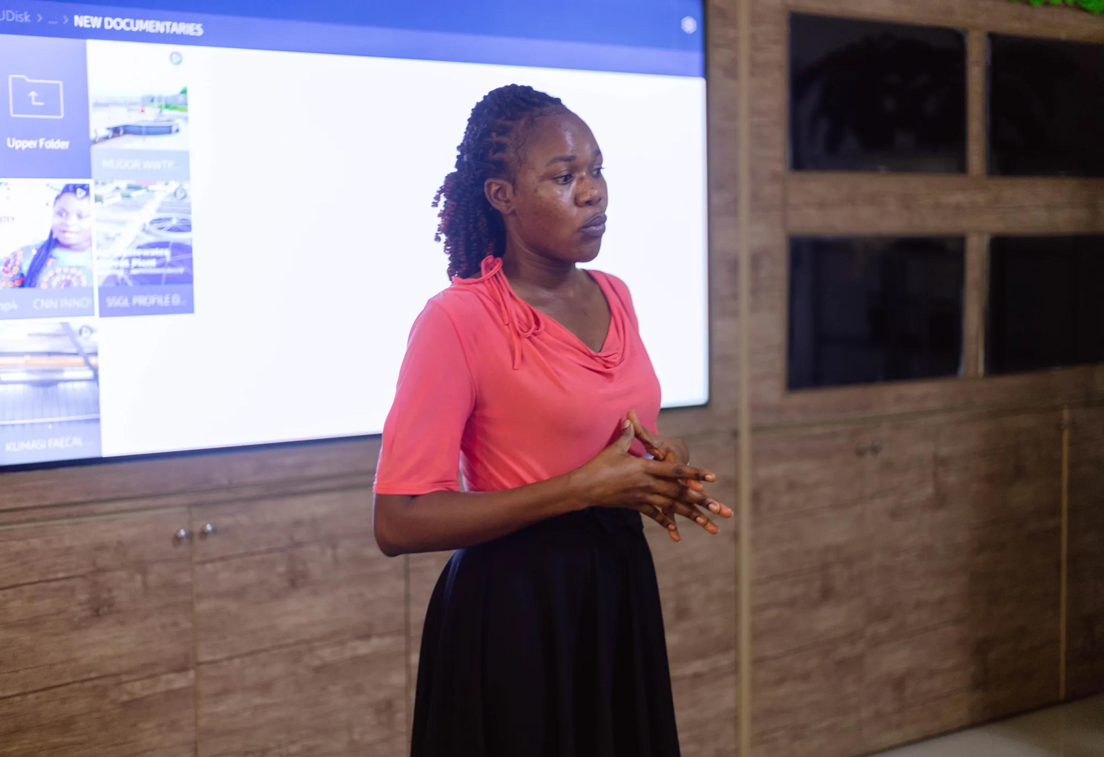 A staff member presenting to the team at Sewerage Systems Ghana Limited