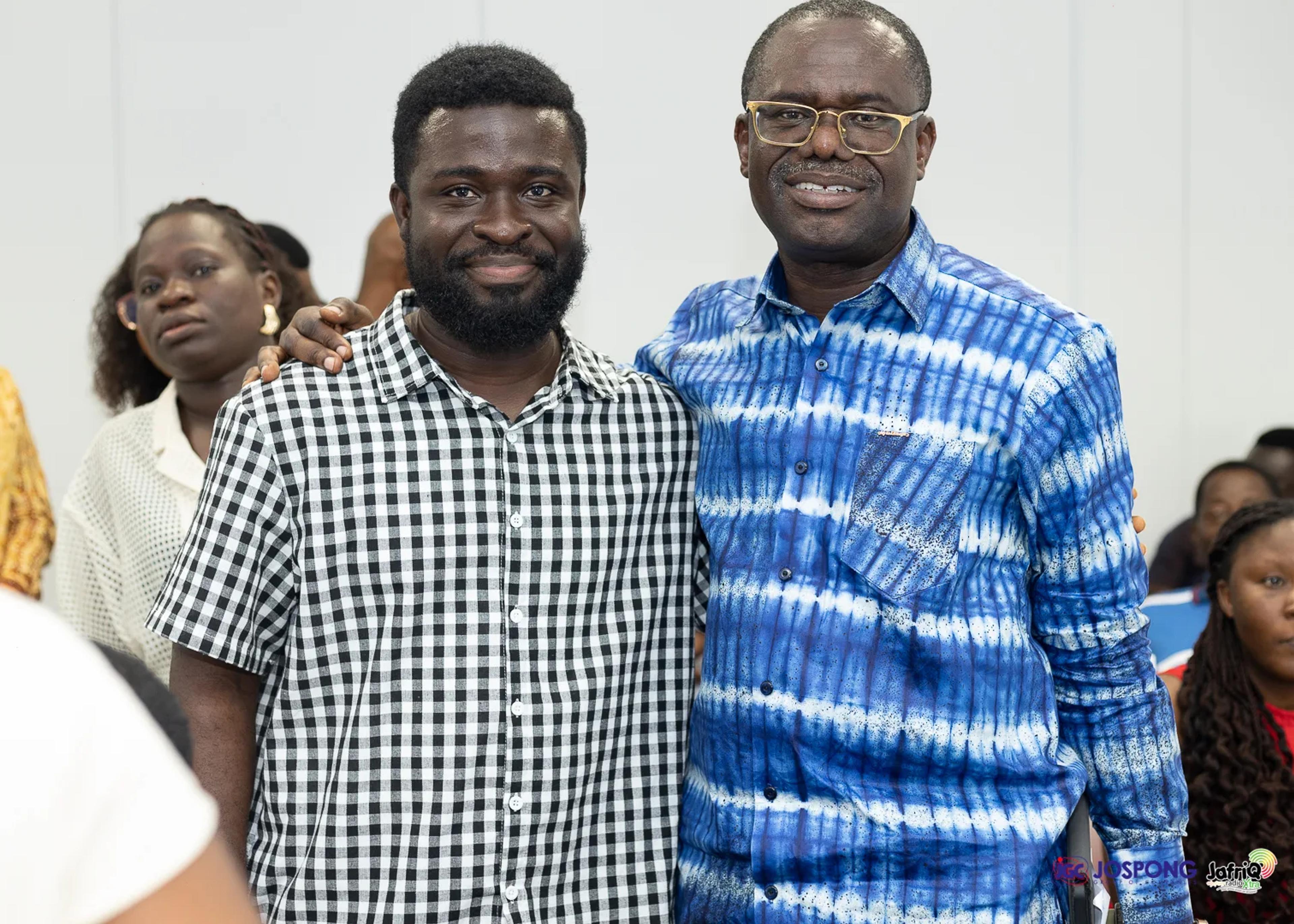 Student and guest pose together smiling in the seminar room