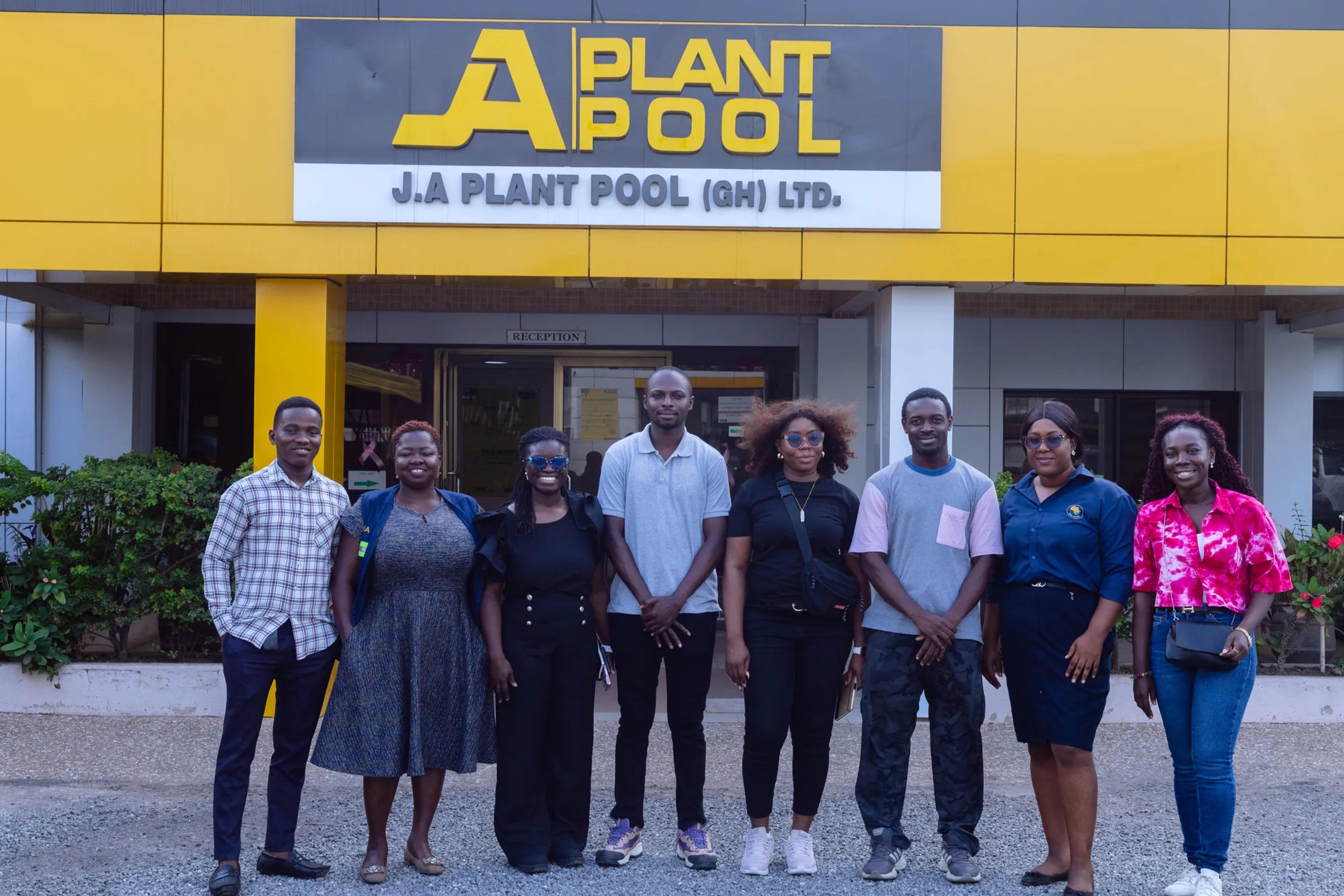 The team and staff in front of the J.A. Plant Pool building