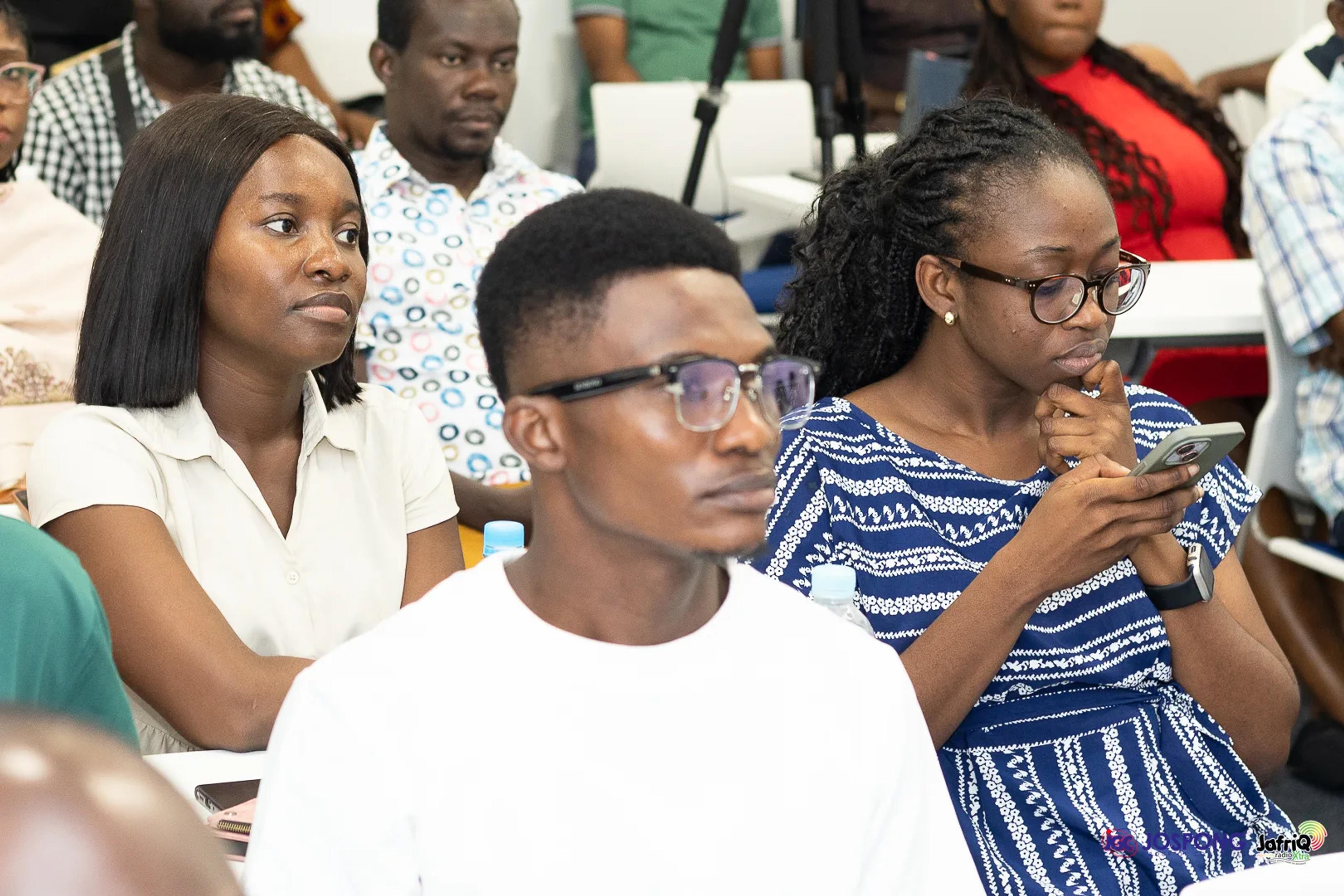 Students in the audience react while following the discussion