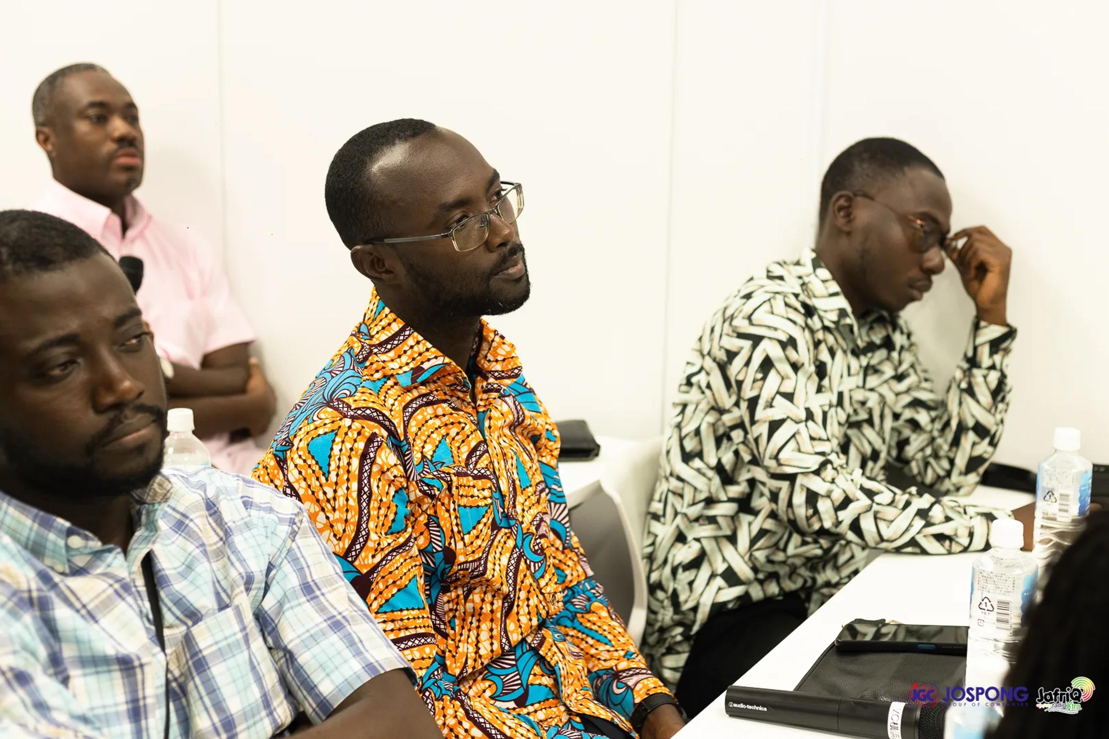 Three attendees listen closely during the Jospong meeting session