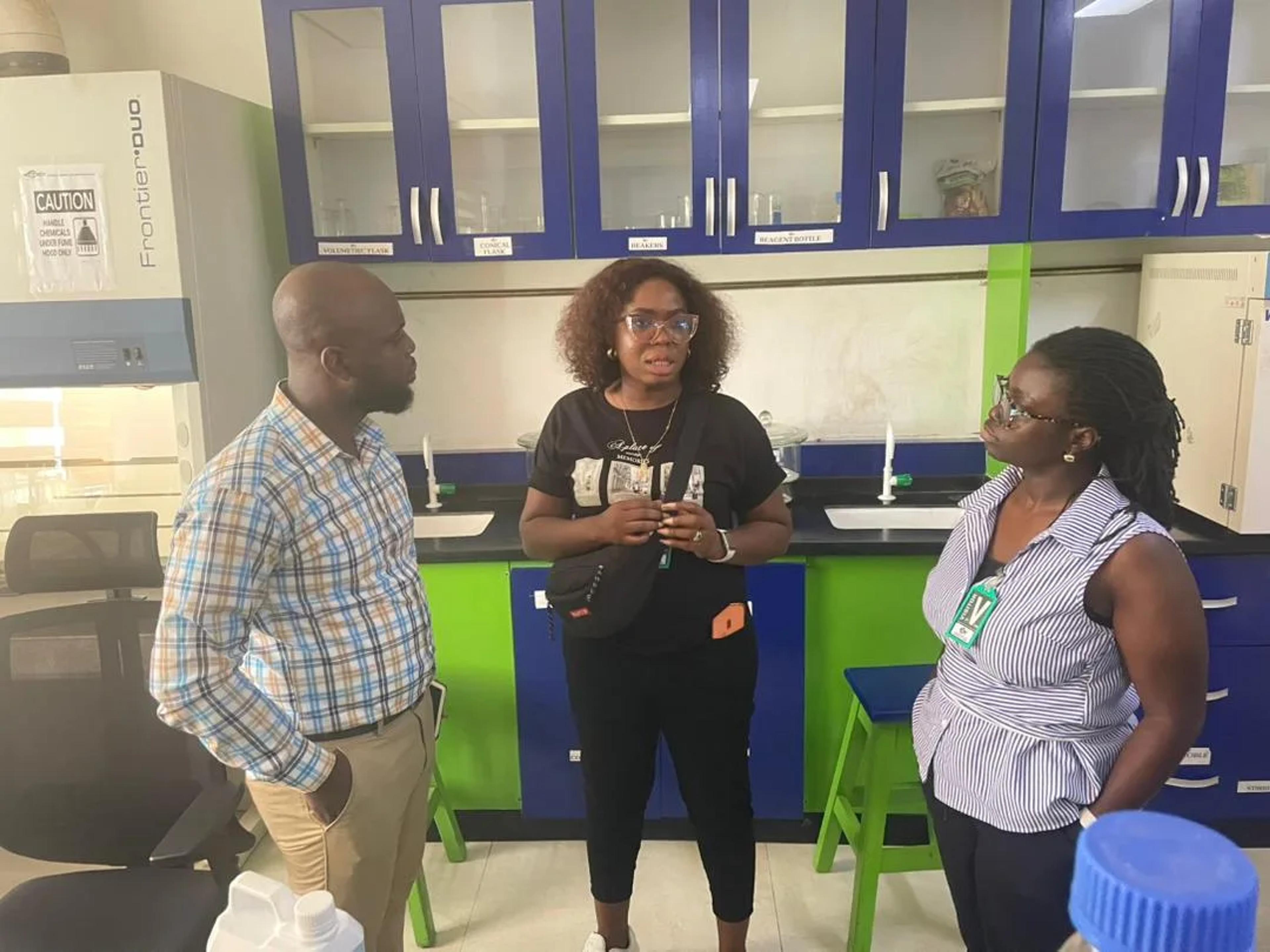 Team members talking with staff in the KCARP laboratory