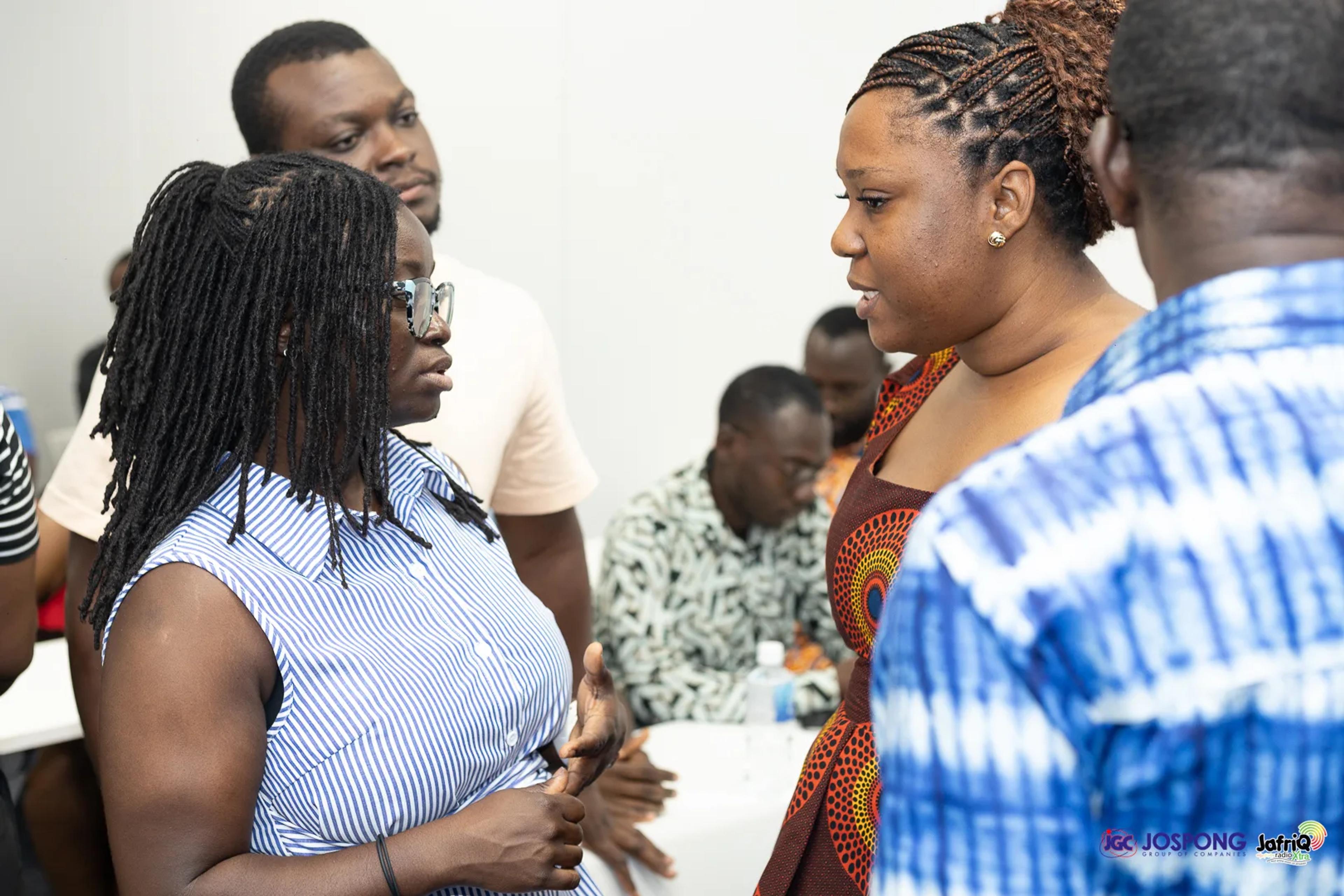 Small group conversation among attendees after the seminar session