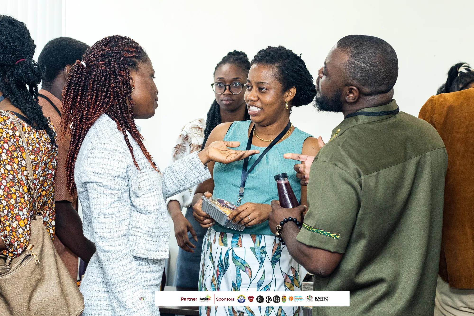 Attendees share a lively conversation during the symposium networking break