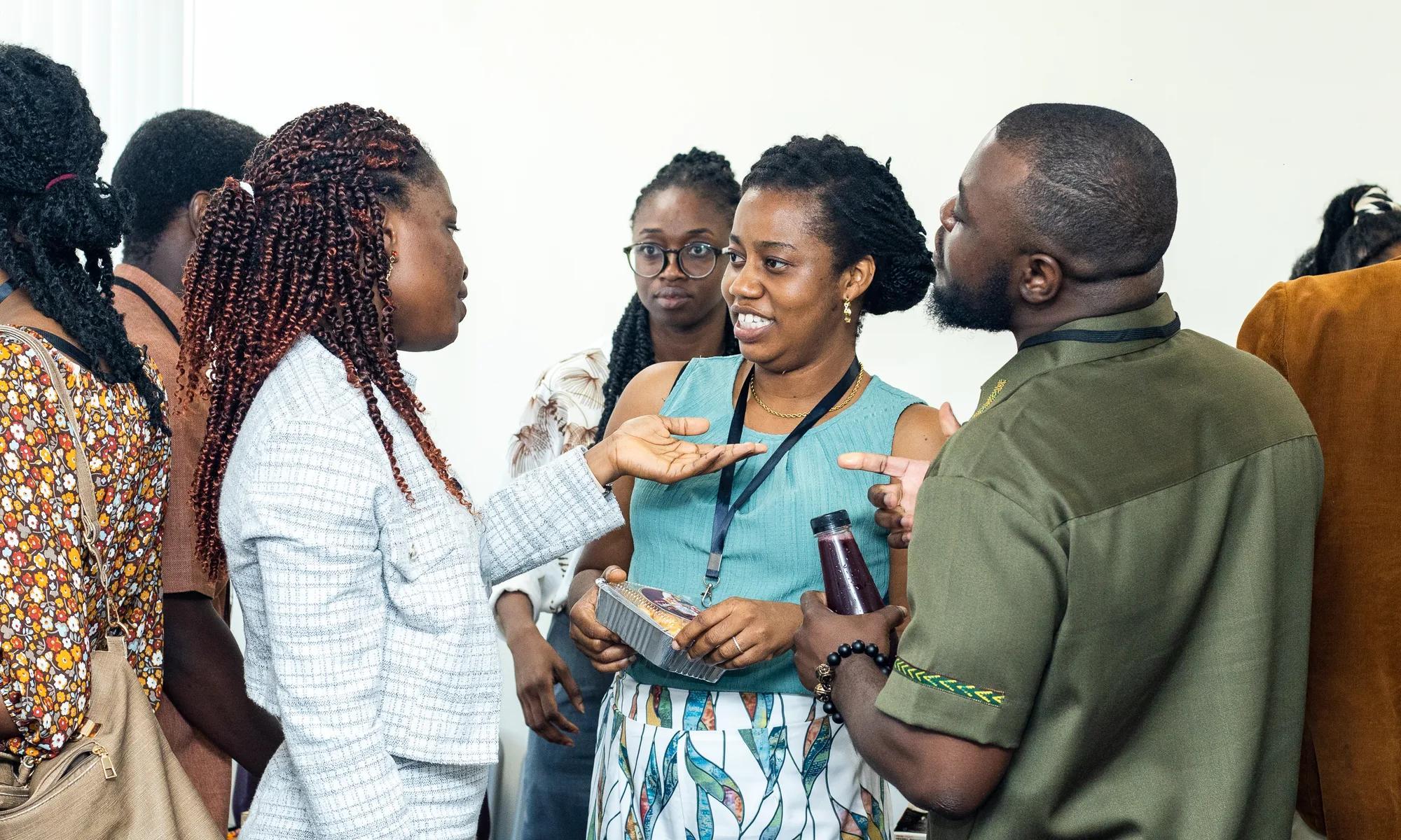 Attendees share a lively conversation during the symposium networking break