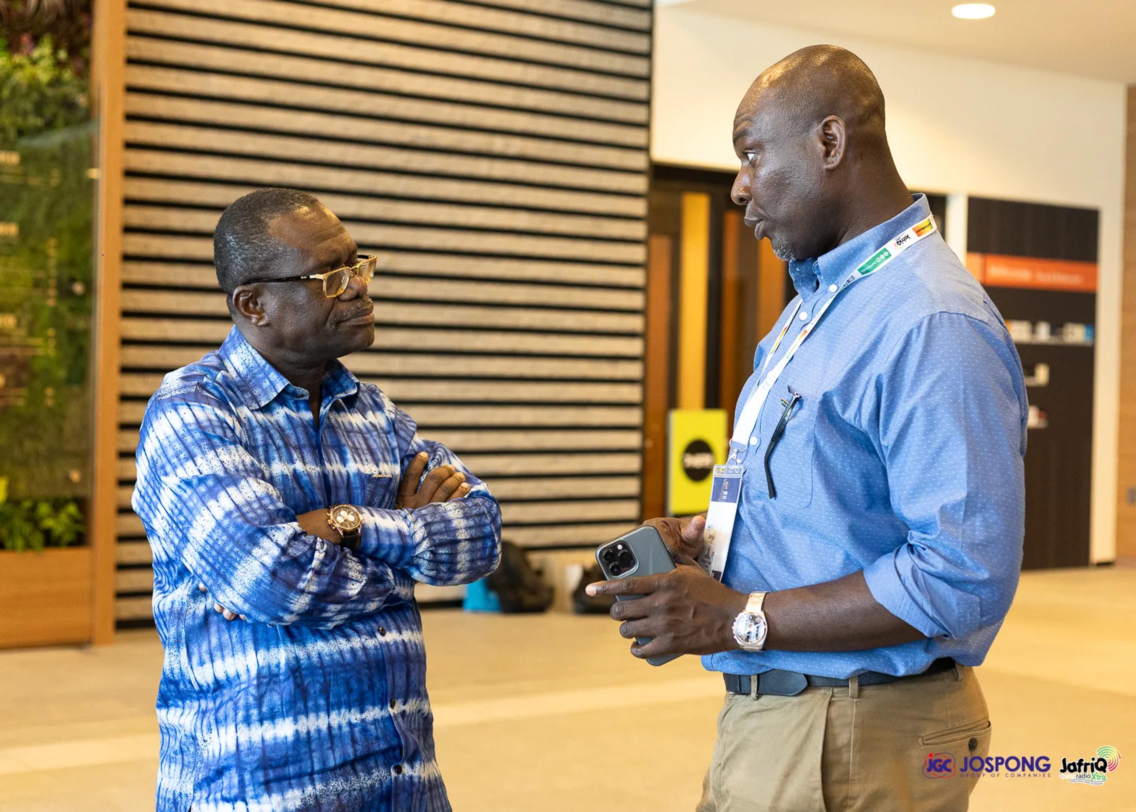 Two men in conversation in the building lobby