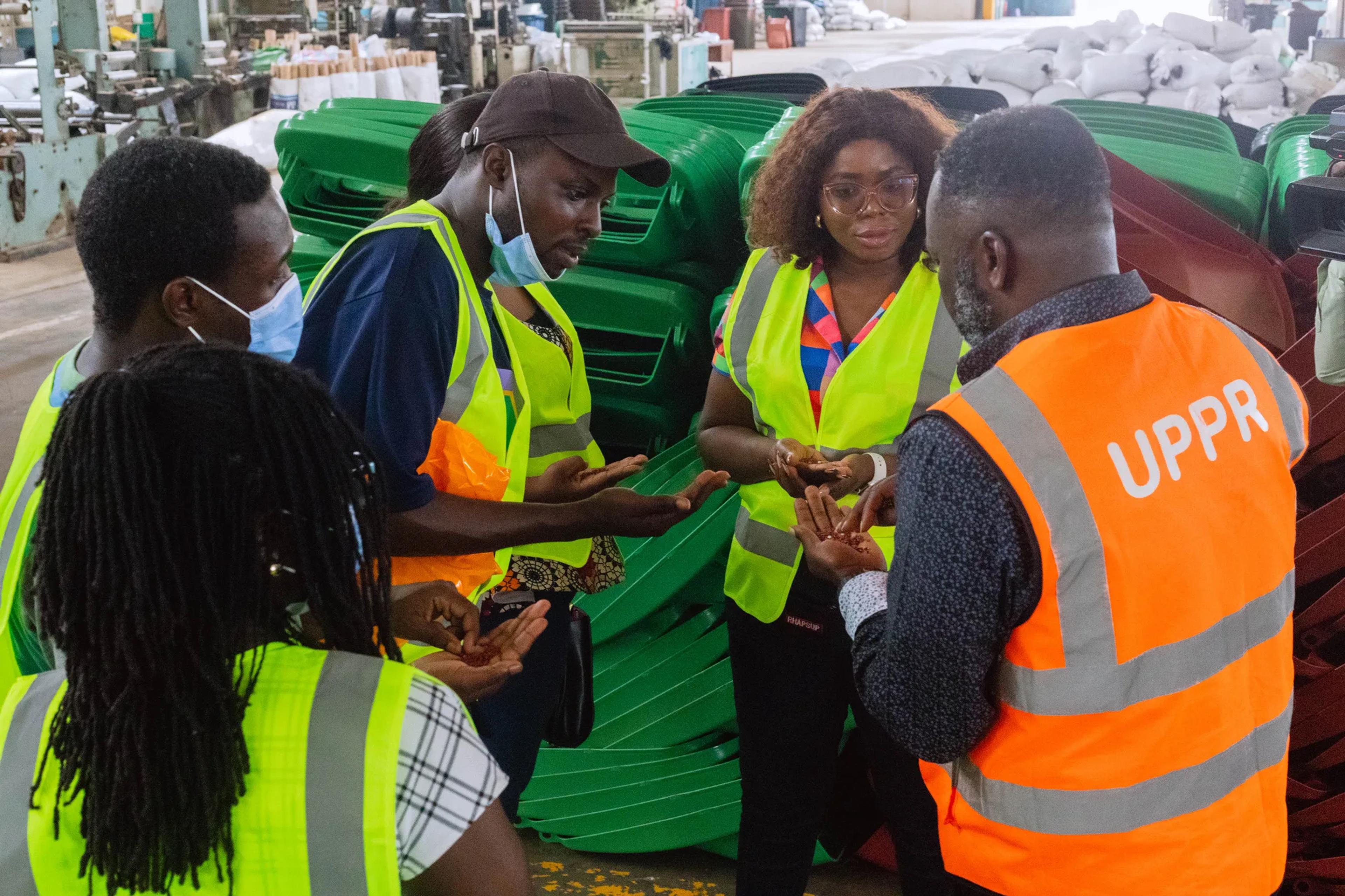 The team looking at plastic waste bins with a UPPR guide