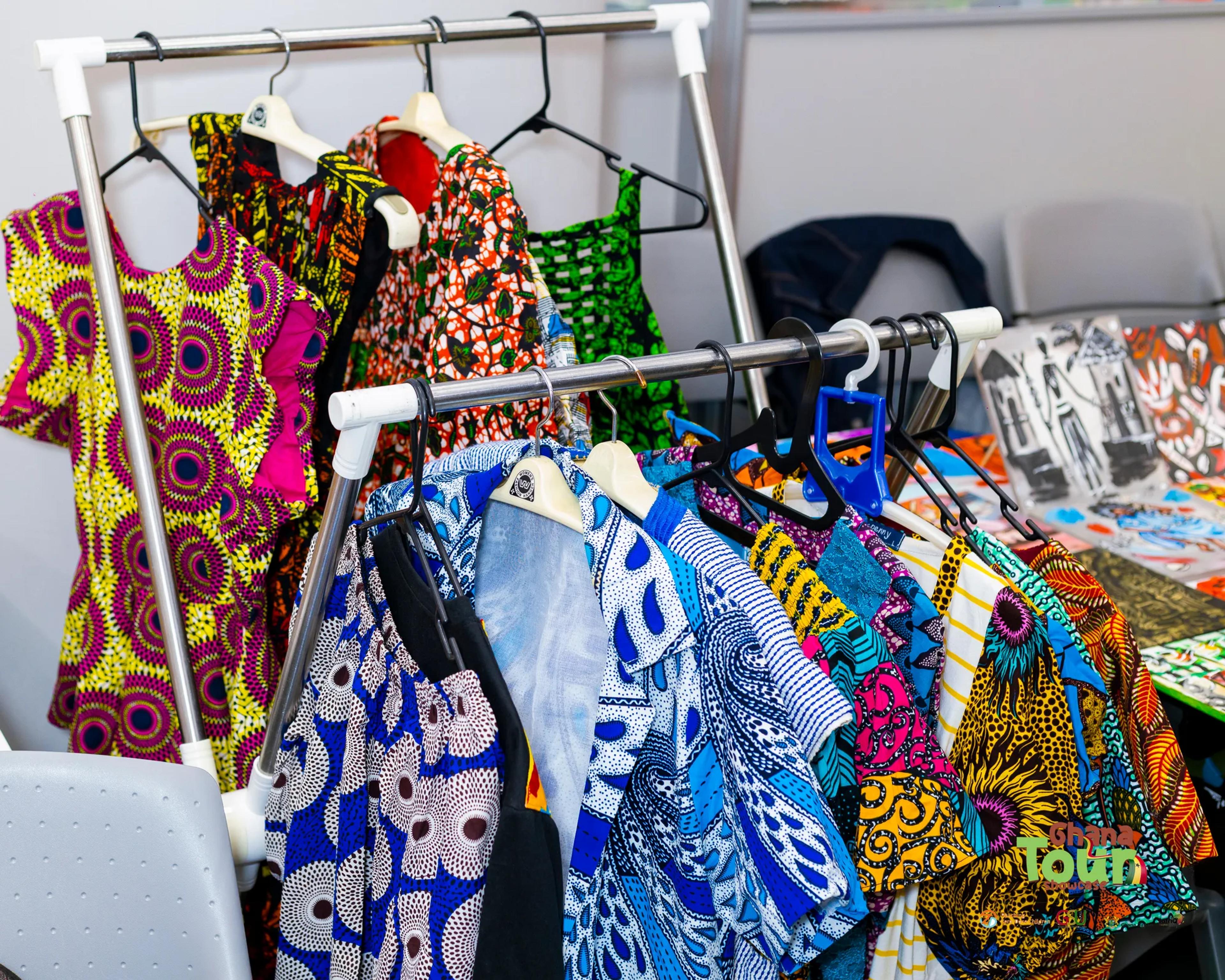 Rack of colourful African print dresses and shirts on display