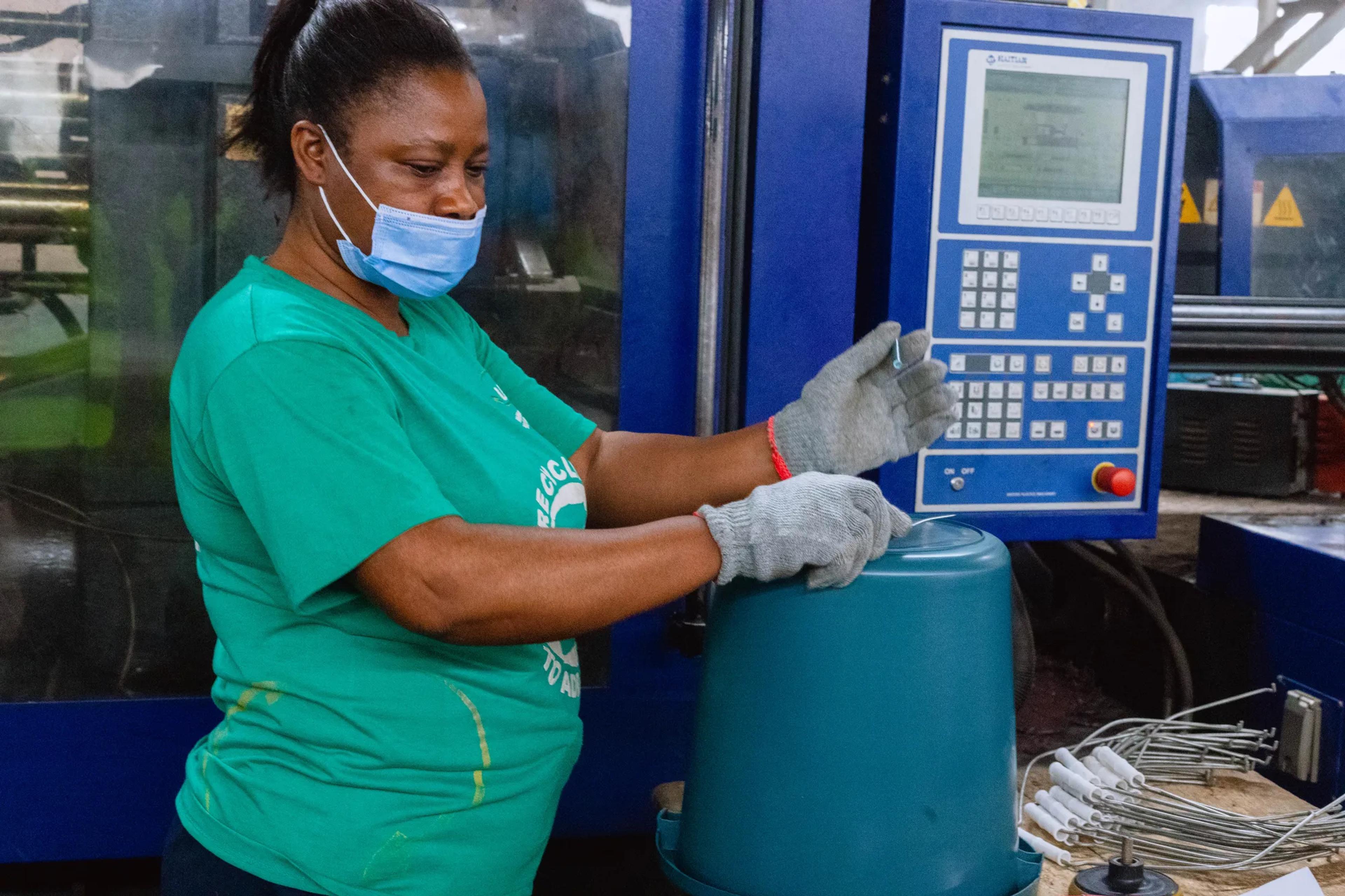 A worker operating a moulding machine at UPPR