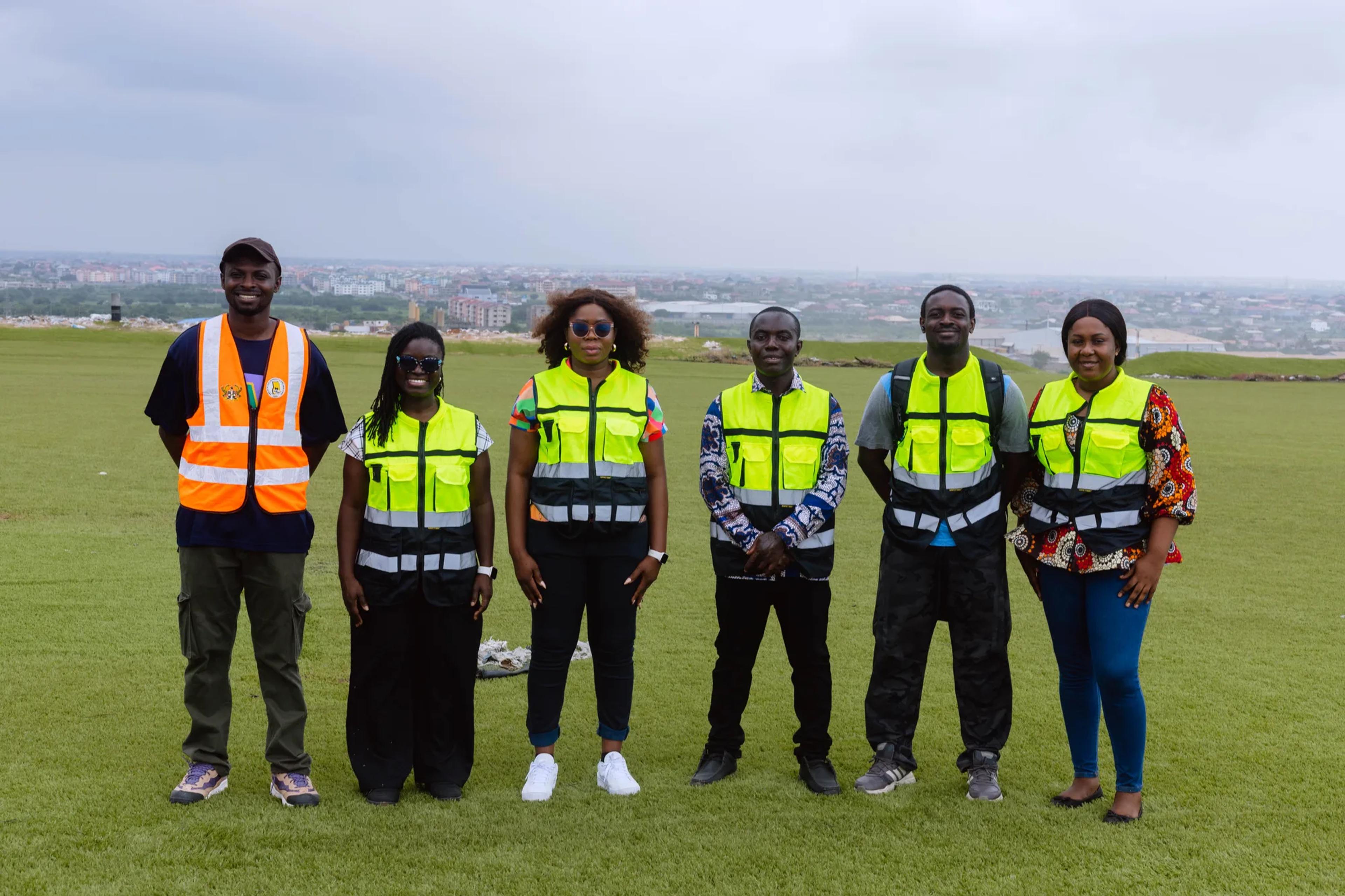 The team on the grassed hill of the Kpone landfill