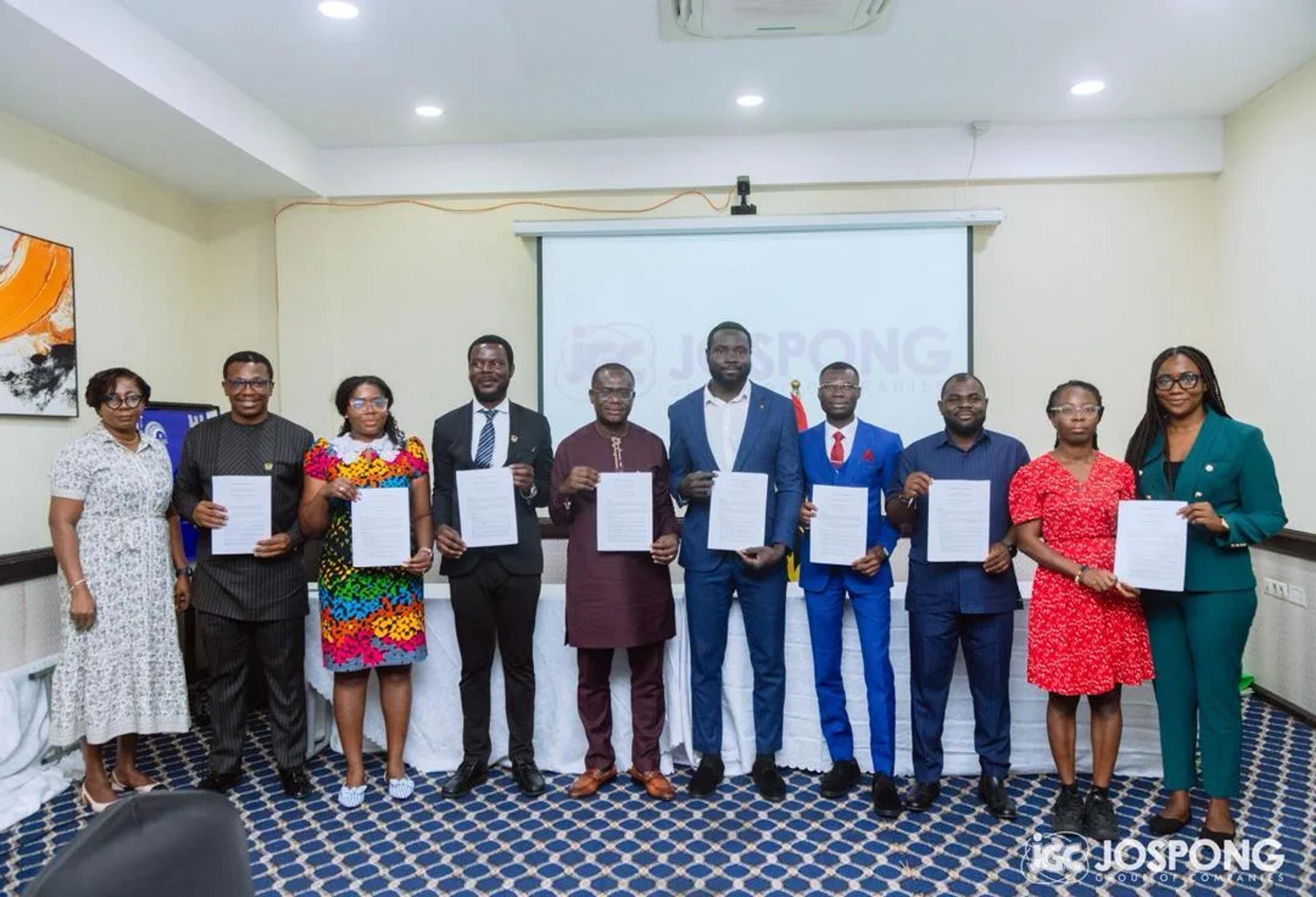 Signatories holding the signed memorandum of understanding at the Jospong Group event in Accra