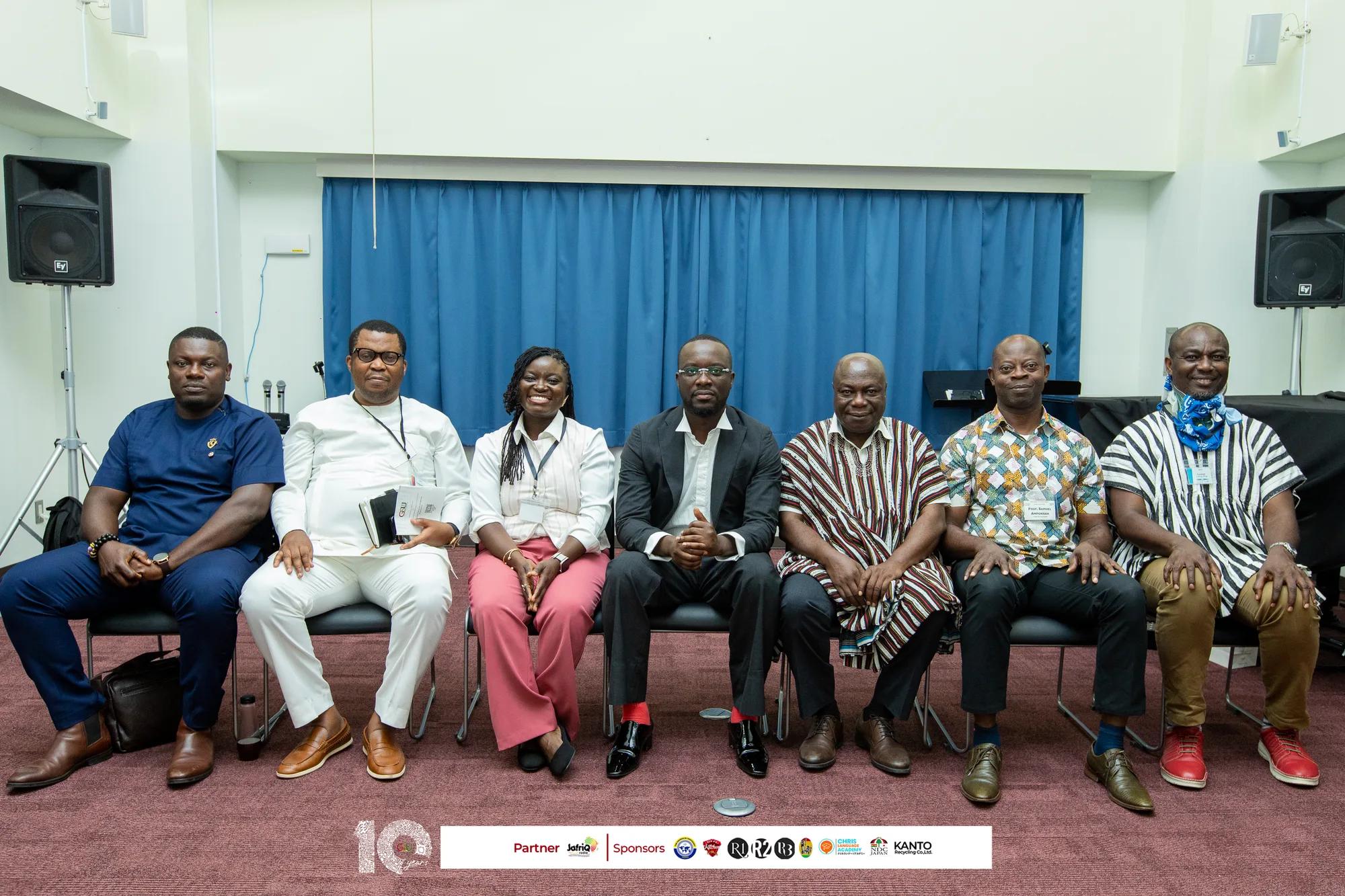 Invited guests and organisers pose for a seated group photo