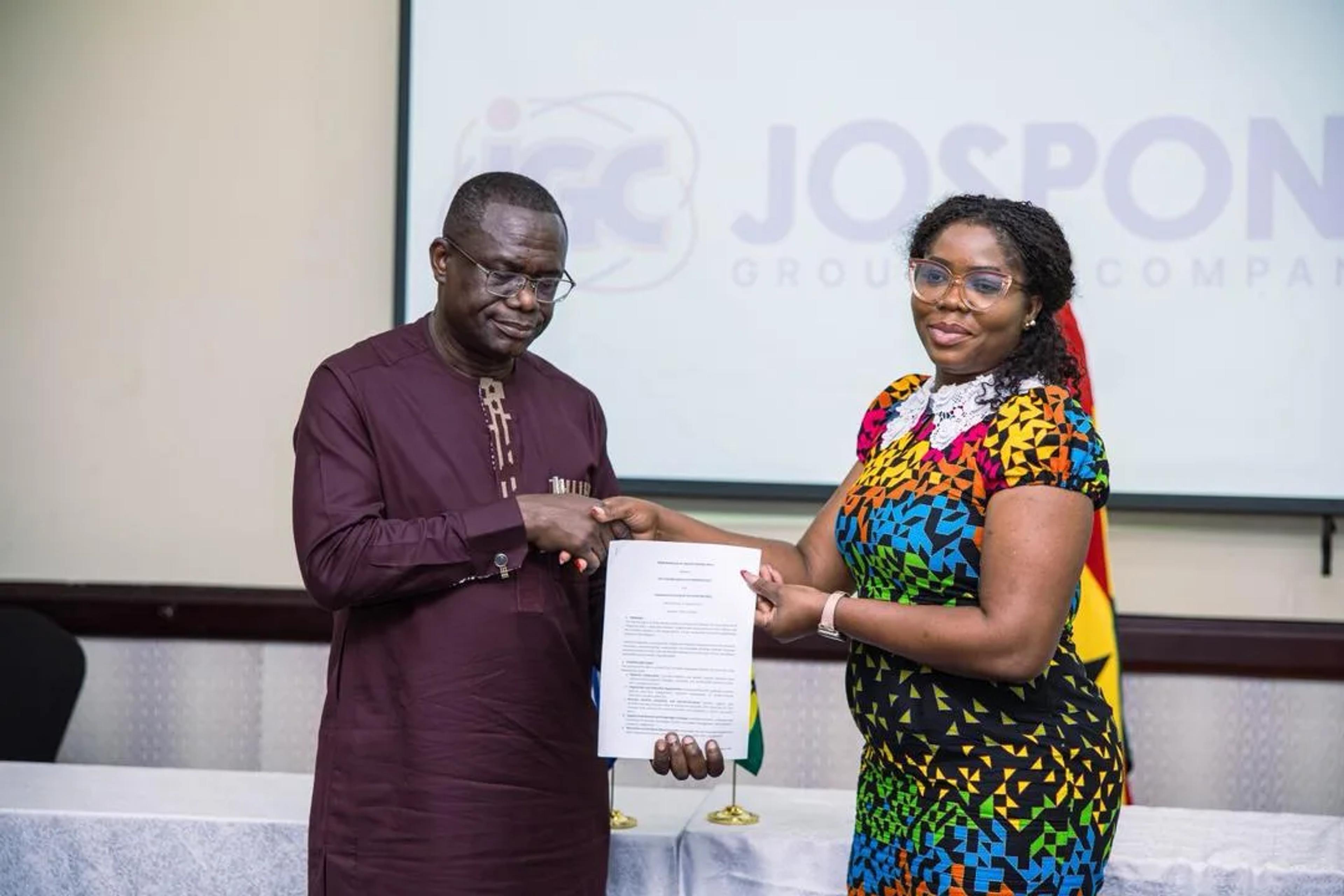 Caroline Awuye exchanging the signed memorandum of understanding at the Jospong Group event