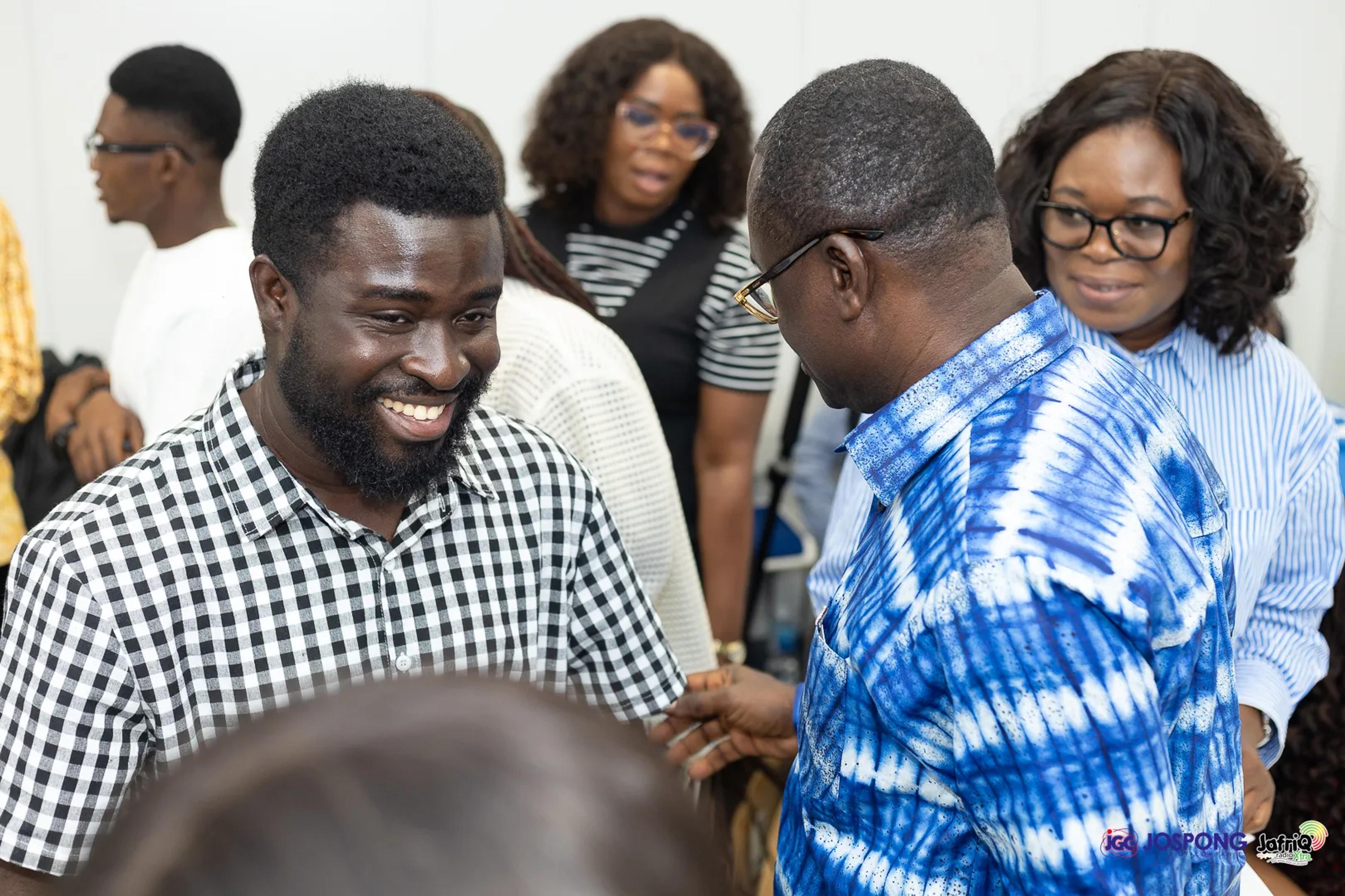 Smiling student greets a guest during networking after the talk