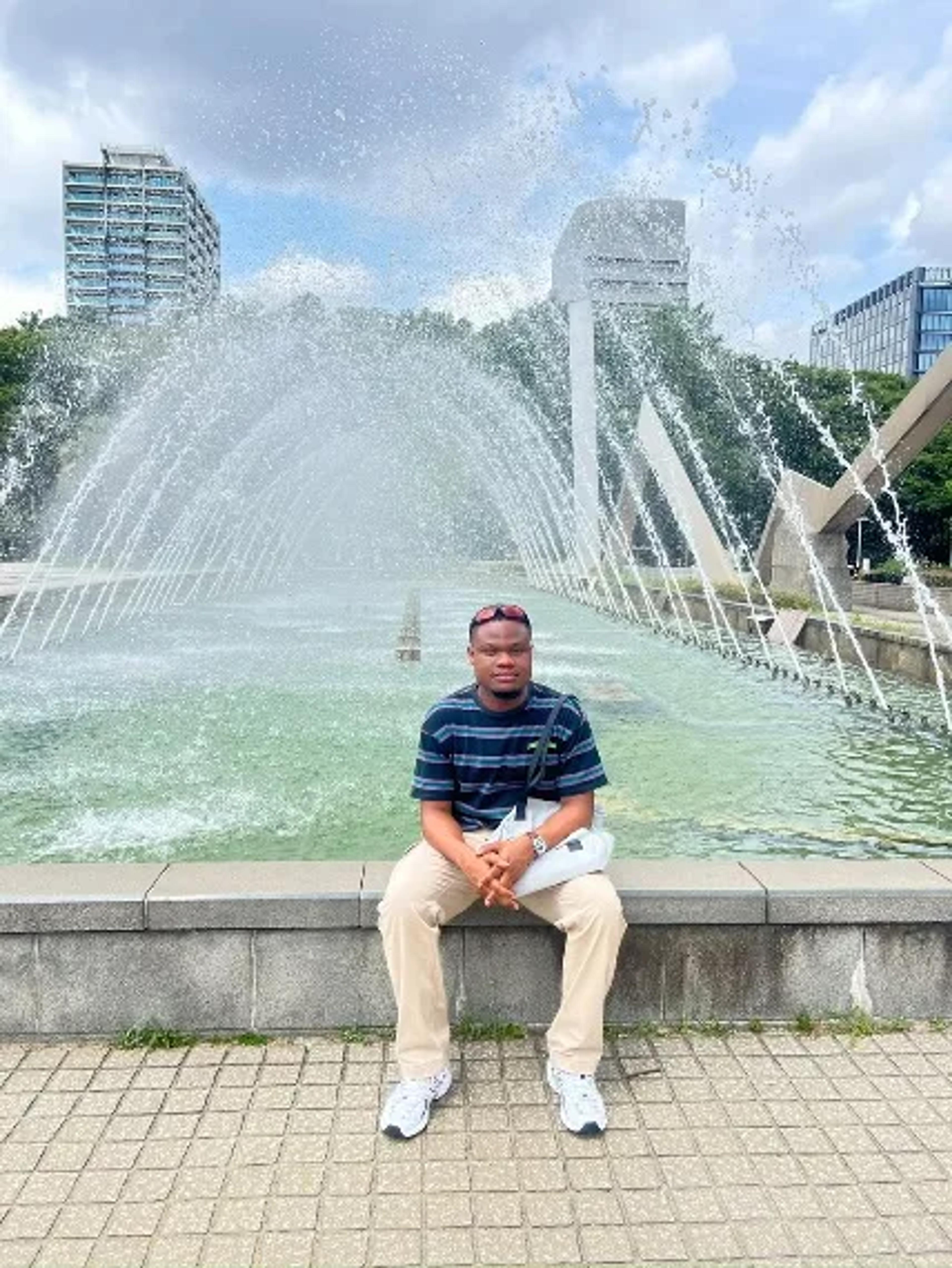 Reinhard sitting by a fountain