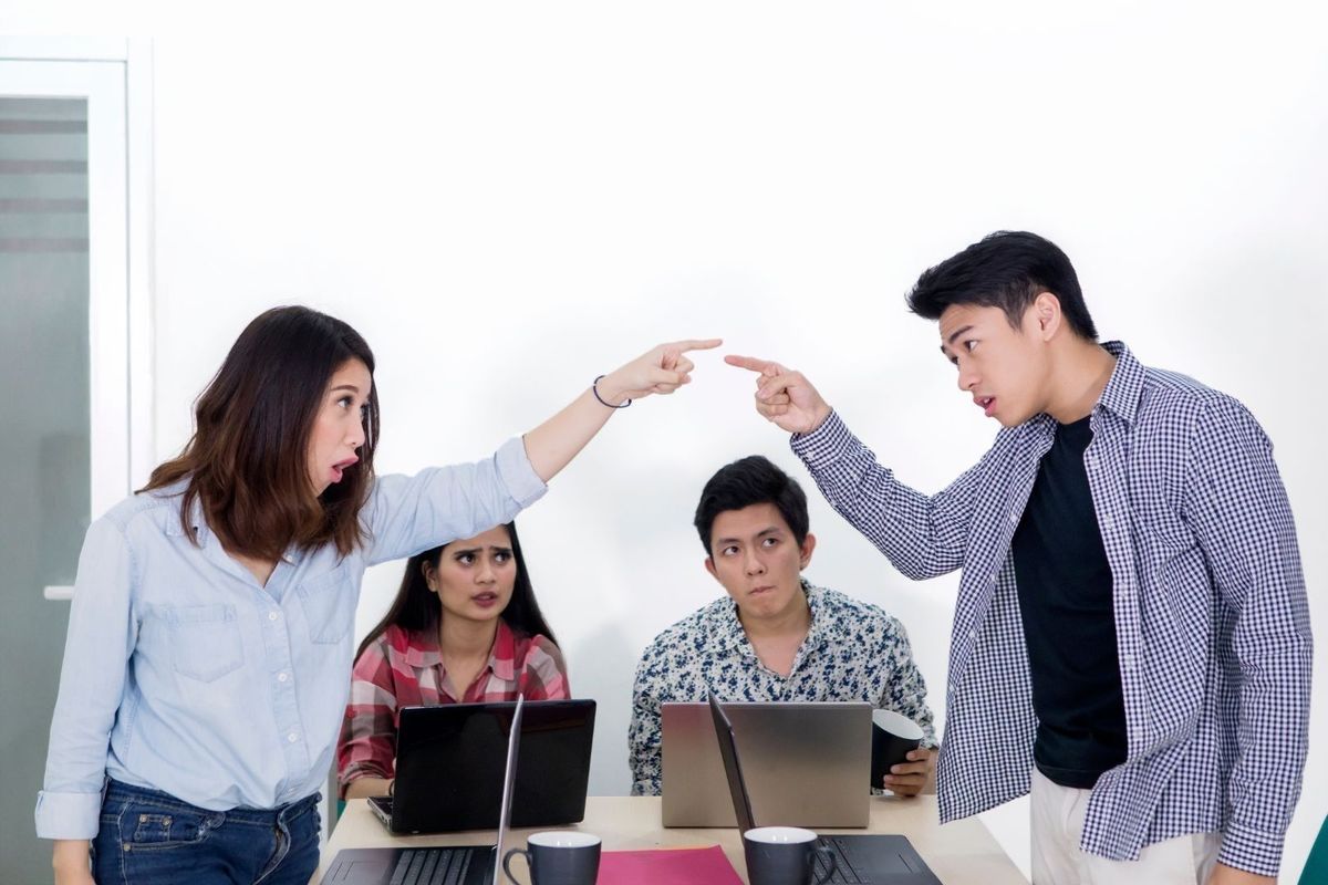 Two people are arguing and pointing fingers at each other, while two others look on with concern.