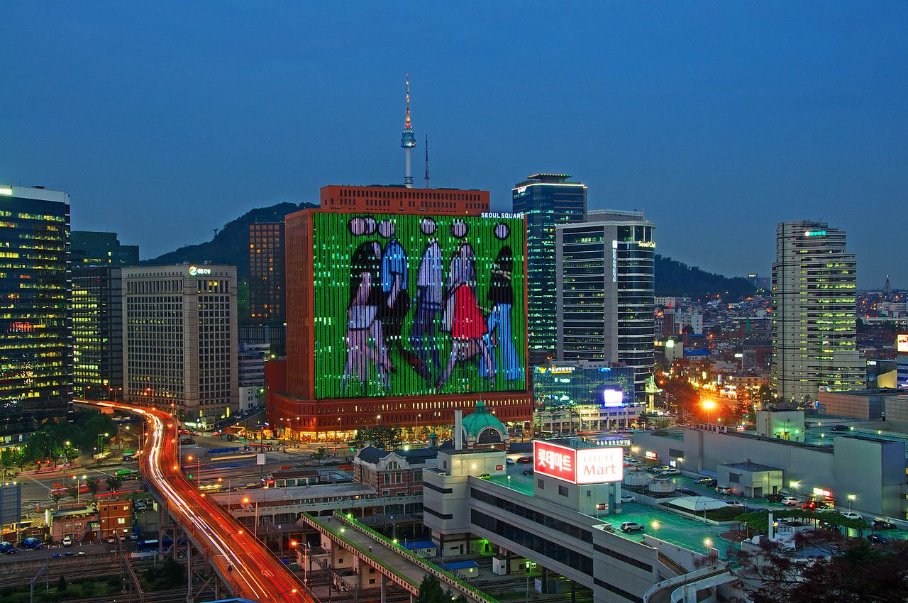 Crowd Project, South Korea 2009. I travelled to Seoul to create and set up this work. Imagine me standing on the roof of that multi-storey car park in the lower right, my laptop screen mapped to the huge building infront.