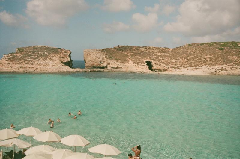 Swimmers in turquoise water at Comino’s Blue Lagoon