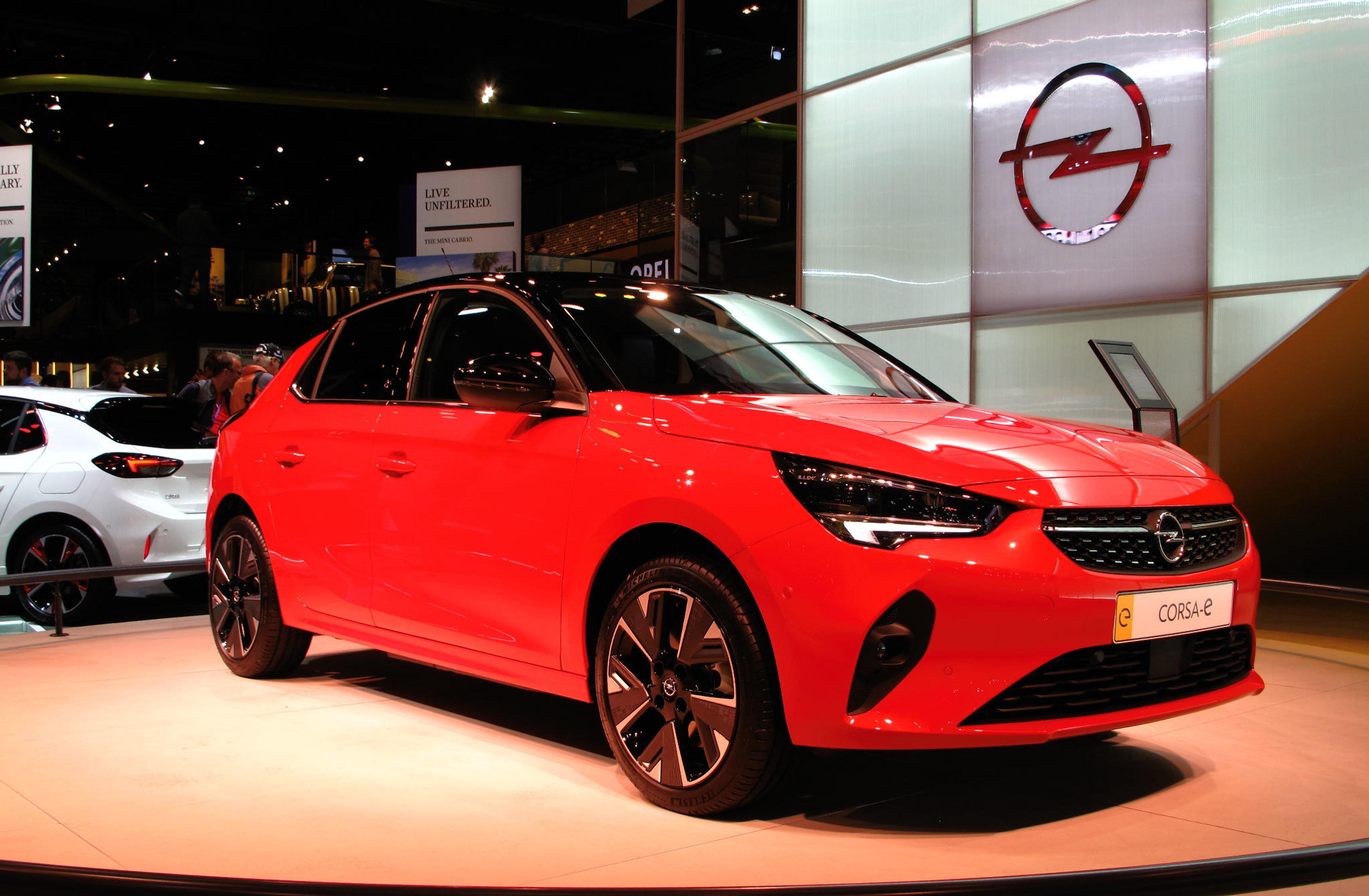 A red Open Corsa-e in a showroom
