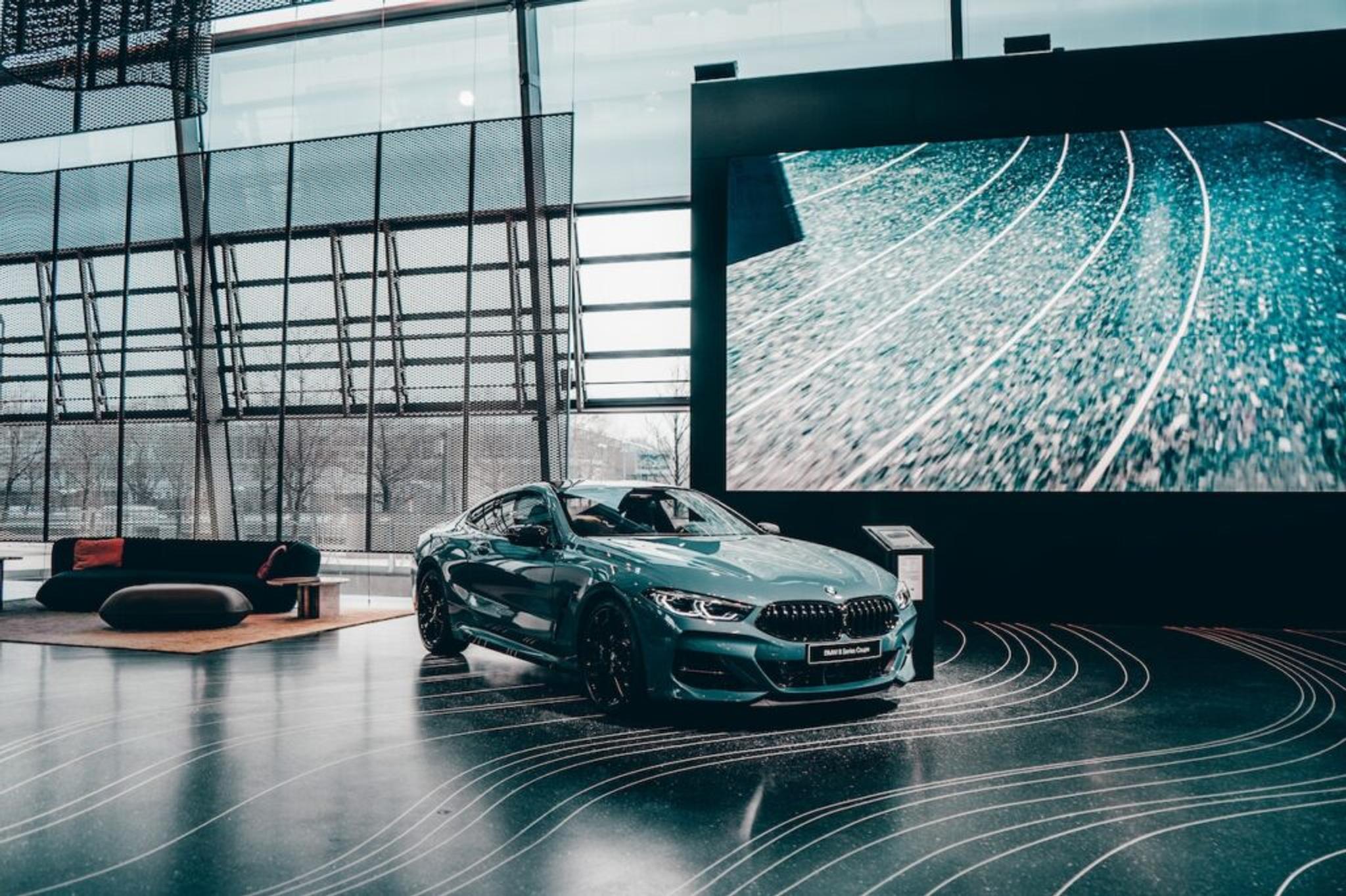 Green BMW coupe in a showroom